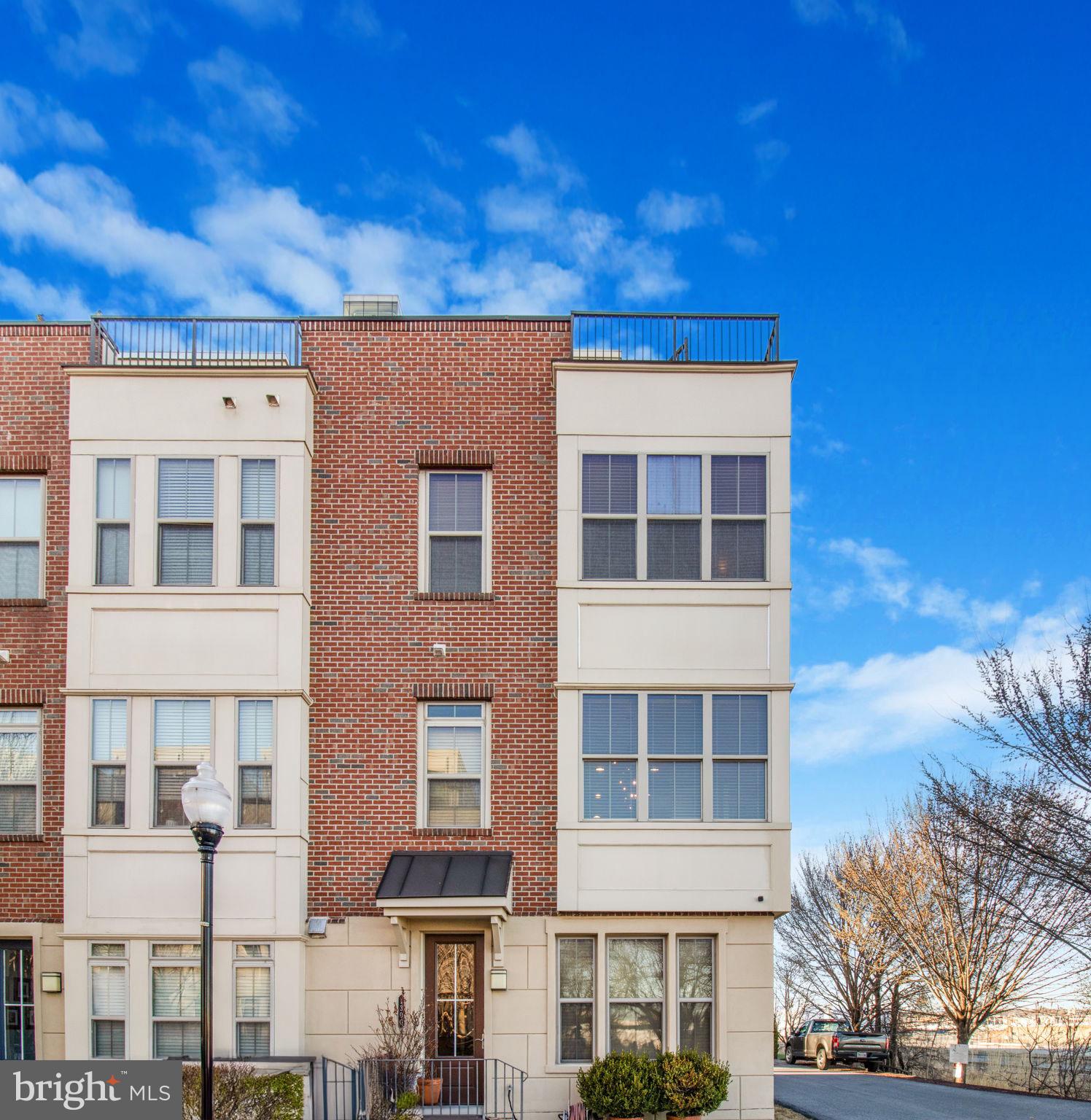Welcome to Key's Overlook in the coveted Locust Point area of Charm City. Perfectly and pristinely positioned as the end of group rowhouse with one of the best views in the neighborhood. Standing four stories tall with an outstanding roof top deck and "sky den", you can and will enjoy the sun rise and set over the Southern Peninsula. Built in 2015 by Beazer Homes, this 3 bedroom, 4 bath (2 full/2 half), modern take on the Baltimore home, shines with gleaming hardwood floors and amenities on all levels, nine- and ten-foot ceilings, and a water view from practically every room. As you enter the home you are greeted by a large den/office or fourth bedroom, and a half bath and access to the rear loading two car garage. Ascend the main stairs and you will find the soaring ceilings and windows, a granite island and countertops with stainless steel appliances. A private dining area with walls of glass and views for formal or casual dining. A large gathering area features a gas fireplace and access to the rear deck, perfect for coffee, libations, or grilling and chilling. The third-floor features three spacious bedrooms, two full baths, and a laundry nook with full-size front-loading washer and dryer. The top floor features a light filled space with a wet bar and beverage station. This is a dream office, reading room, music room, or staging for those outdoor parties. Step out to the rooftop deck for spectacular views of the inner harbor, the waterfront, and Fort McHenry. Easy access to 95, BWI, and the trains. Come life the life in Locust Point!