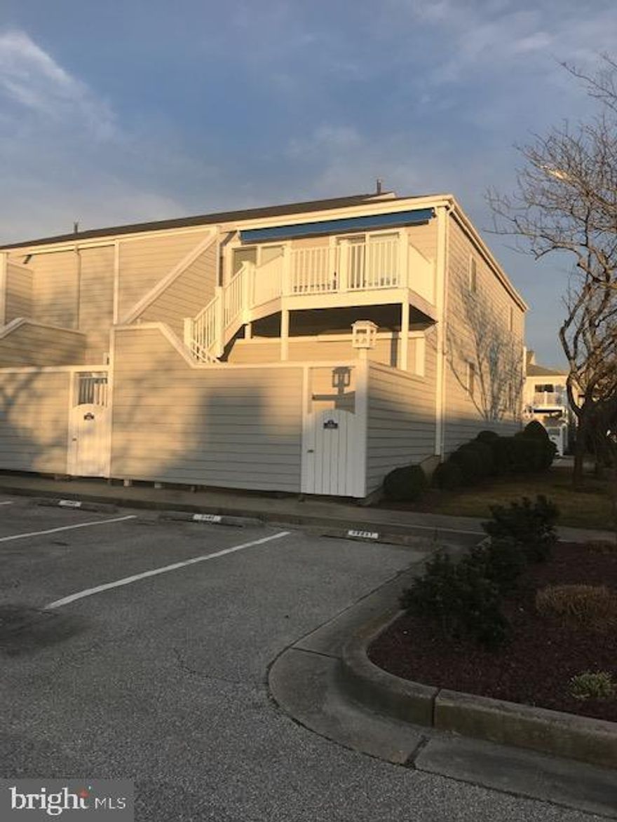 Coastal Style Living: Villa designed 2 bedroom, 2 full baths, deeded boat slip, non-rental - low condo fees.  New wood flooring in living, dining & kitchen; new carpet in bedrooms; new tile in master bath; new  slider doors in living room & master bedroom which open onto  new exterior decking; large deck area with retractable awning; offers extra spacious living area.  Beautiful bayside community & well maintained.  One block to Northside Park which offers many year round activities; jogging trail, Winterfest of Lights, 4th of July celebration; 2 blocks to the beach and steps to your own deeded boat slip.  Easy access to Sinepuxent Bay.