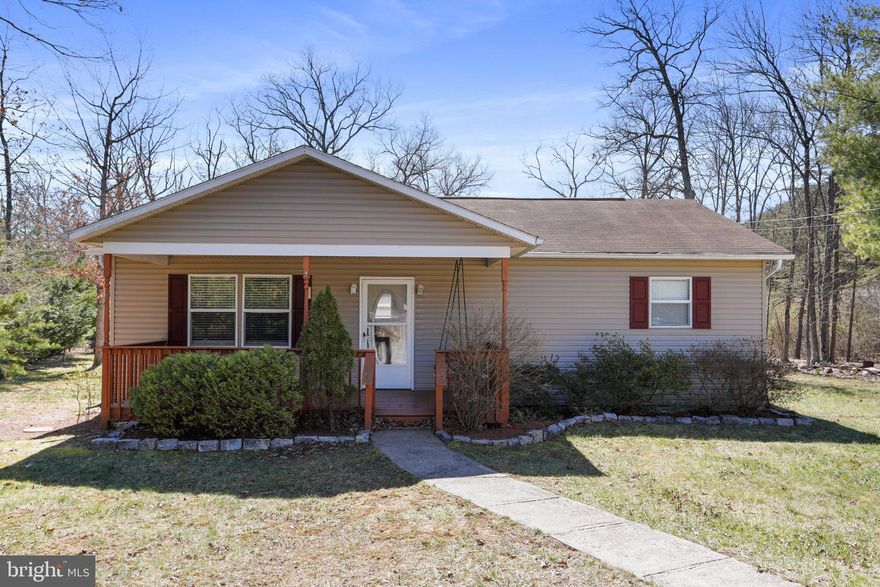 Unrestricted lot AND oversized 1000 sq. ft. detached 4 car garage and/ or workshop with 9' doors! Move in ready, freshly painted & some new LVP flooring! The current owner had the HVAC coils  AND the duct work cleaned! Ranch style home with 3 bedrooms and 2 baths! The inside is cozy and quaint, but has room to spread out with a bonus sitting area by the wood stove! The exterior boasts a covered front porch and rear deck and patio area! The rear and side yards will be perfect for summer games and get togethers! Cacapon State Park is a true gem and offers golf, horseback riding, hiking trails, a swimming/ fishing lake, spa and dining lodge! Even better... the VA line is also just minutes away and downtown Berkeley Springs is a short drive!