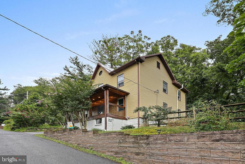 Own a piece of history! This charming colonial built in 1892 and located in the Historic District of the Town of Sykesville is ready and waiting for you! This home has historical charm along with modern updates. The cedar front porch with hand hewn logs custom built by a local architect is a perfect spot for a quiet evening. The main level features a living room with hardwood floors and a freestanding pellet stove that can heat the entire main level and a stunning cedar shiplap wall with a built-in reading nook. You will also find on the main level a separate family room with luxury vinyl plank flooring, an updated kitchen with granite counters and custom oak cabinetry, and a beautiful sunroom/breakfast room that leads to a screened porch with timber flooring overlooking the landscaped rear yard. The upper level features three roomy and bright bedrooms with plenty of closet space, and a spacious full bath. The air conditioning unit is new in 2025 and has a 10 year warranty available. This lovely colonial has over 1700 finished square feet of interior space along with plenty of outdoor living space. Located just off of Main Street Sykesville, you are steps away from quaint shops, restaurants, and Town events like the Farmers Market, Fall Festival, Craft Beer Festival, and more. Come be a part of the Coolest and Best Small Town in America!