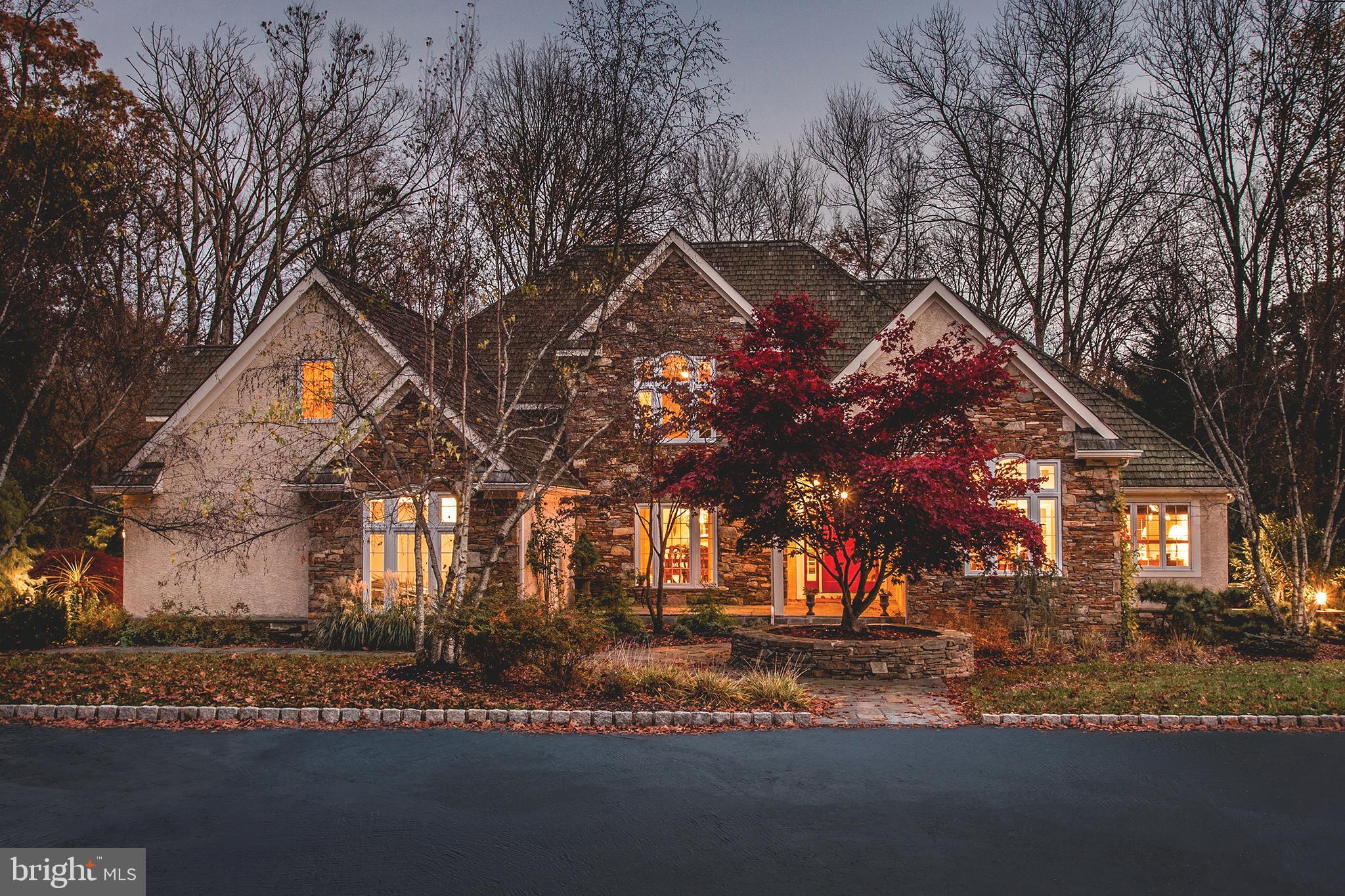 Beautiful stone home located on a gorgeous, private 3+ acre lot with mature trees, spacious lawns and lovely landscaping which backs up to an additional, fantastic 10 acres of protected, common area complete with a pond and swans. This unique one-of-a-kind home offering beautiful and spacious rooms, has been immaculately maintained and improved to the highest standards with many remodels done within the last 5 years. The home features a large, bright first floor master suite with a comfy sitting room, huge master bath and his and hers walk in closets. There is an additional first floor master suite at the opposite end of the home with its’ own entrance making it a perfect spot for an au pair, in-law or guest suite. The new gourmet kitchen with granite counter tops and large island with breakfast bar opens to the lovely equally large and bright family room with stone fireplace and 9+ foot tray ceilings. A formal living room with views of the property, dining room and office are also found on the main level. The second floor offers 3 additional large bedrooms, 2 full baths and a bonus room. The flexible floor plan offers possibilities for an additional home office or possible 6th bedroom. The finished basement is yet more space for family fun with a media room, huge game room, wet bar, half bath and provides plenty of storage areas. The newly redone deck off the great room overlooks the mature landscaping and pond. Set far from the road, this custom home checks off all the boxes for today’s modern living. Conveniently located to Doylestown and New Hope. For the commuter it is a perfect location, 70 minutes to NYC, 50 minutes to Philadelphia and 25 minutes to Princeton.