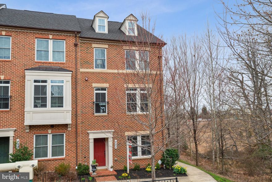 OPEN SUNDAY 3/10, 1-3PM!  A SHOWCASE on a PREMIUM LOT!! Rare opportunity to own this large 4 level END-UNIT townhouse with 2880 sq ft of living area in the much-sought after Parkland community.  
Surrounded by woods and large green space, encompassing a tot lot and an open field, this 2014-built, 4 bed/3 full bath/2 half bath home has the unique privacy needed to enjoy its endless walls of windows.  The entry level features a den/home office with glass French doors, a powder room and access to a rear loading 2 car garage. The open concept main floor boasts hardwood floors, a chef’s kitchen with a gas cooktop, stainless steel appliances, a 2-tier granite island with seating and a large pantry. On one side of the kitchen is a 2nd powder room and a dining area with large windows facing the woods; on the other side is a spacious living room with a stunning gas fireplace flanked by gorgeous built-in custom shelving, and two sets of French doors leading to a generous deck. On the 3rd level are 2 secondary bedrooms and the owner’s suite which highlights 2 walk-in closets and an en-suite bathroom with dual sinks, an oversized shower and separate water closet. The washer and dryer are also conveniently located on this level. The gorgeous 4th level a true 
bonus space, ideal as an additional bedroom suite, a playroom, a home office or an entertainment area. 
Complete with a full bathroom and expansive closet, this flex space leads out to an expansive rooftop deck, a 
favorite spot to entertain or relax.  Enjoy all the Parklands community has to offer with a clubhouse, swimming pool, tennis courts, fitness center, meeting room, tot lots and walking paths throughout. In an 
unbeatable location only steps from the MARC Train Station and minutes from Downtown Crown, RIO, the Kentlands and I-270, this gem is sure to WOW even the most discerning buyer!