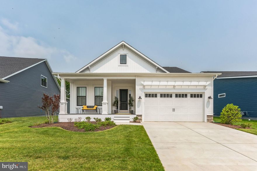 New Construction • Delivery Late Spring 2026

Welcome to The Eastwood—a charming, cottage style ranch home offering true first floor living in one of Delaware’s most exclusive, award winning coastal communities. Thoughtfully designed with 1,780 square feet of refined comfort, this 3 bedroom, 2 bath residence blends modern luxury with warm, inviting character.

Step inside to upgraded LVP flooring throughout, upgraded lighting packages, and an open concept layout anchored by a stunning gourmet kitchen. Enjoy upgraded quartz countertops, a large center island, stainless steel appliances, built in double wall ovens, built in cooktop, French door refrigerator, stainless steel appliances and a farmhouse sink. The adjacent great room features a cozy fireplace and opens seamlessly to the rear screened porch and a 12’ x 14’ exterior deck—perfect for relaxing or entertaining.

The upgraded primary suite is a true retreat, showcasing a spa inspired bathroom with a frameless glass shower enclosure, tile to the ceiling, a tiled pan floor, and three shower heads for a luxurious experience. Additional highlights include a dedicated laundry room with cabinet package and utility sink, natural gas heat, gas cooking, a tankless Rinnai hot water heater, and a 4’ conditioned crawlspace for enhanced efficiency and storage.

Outside, enjoy a covered front porch and a homesite positioned within a serene, natural setting—surrounded by open space, wildflower plantings, and thoughtfully preserved landscapes.

Unmatched Coastal Location:
Just a 15 minute bike ride to the beach, ½ mile to the Lewes–Georgetown Bike Trail, and 1 mile to the Lewes/Rehoboth Canal. Minutes from Cape Henlopen State Park, the Cape May–Lewes Ferry, and all the charm of historic Lewes. Ideally situated east of Route 1 for effortless coastal living.

Resort Style Community Amenities:
Live in the 2025 Regal Award–Winning Community of the Year, offering an unparalleled lifestyle:

• Zero entry resort style pool & hot tub
• Pickleball courts & a tennis court
• Community garden
• Outdoor pavilion, grill areas & fire pits
• Horseshoes, shuffleboard & bocce ball
• Tot lot & outdoor workout space
• Nature trails, wildflower meadows & honey bee hives
• Expansive great lawn for events
• Lifestyle Director coordinating yoga, Pilates, Zumba, strength training, cooking demos, lunch and learns, wine & beer tastings, brewery tours, live music, and more

A Rare Opportunity
Homes here are selling fast with limited availability. This highly sought after, one of a kind coastal community offers an unmatched blend of luxury, nature, and lifestyle. Don’t miss your chance to own The Eastwood—a brand new home in an award winning setting, ready just in time for Summer 2026.

For a full list of included features, please contact our sales representatives.
Photos are for illustrative purposes only and may not represent the exact home or finishes available.