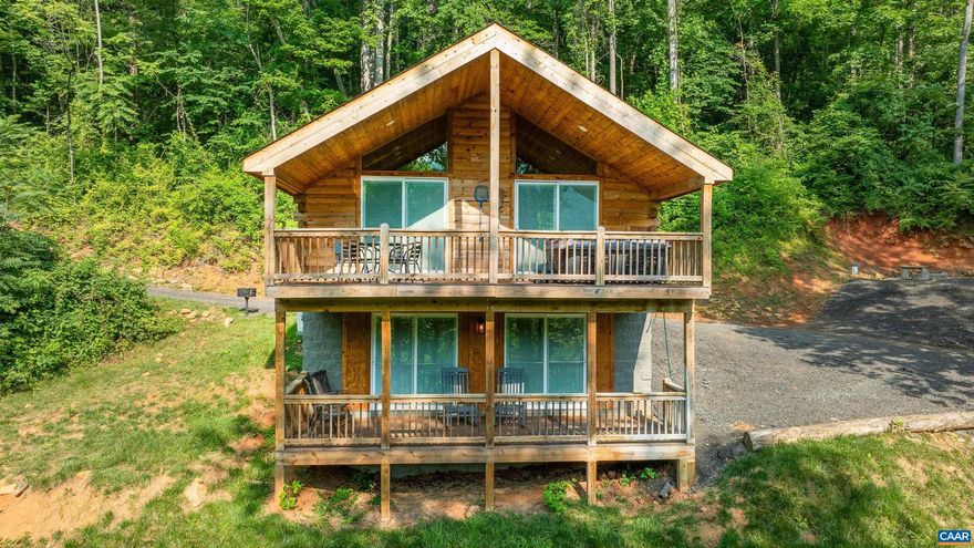 Nestle yourself in the log cabin of your dreams along the base of the Shenandoah Mtns and minutes from Skyline Dr. An easy to drive, state-maintained road leads you to the private Mae Dr, where you'll find this cabin tucked into the woods on 1.75 acres. Built in 2021, buyers have peace of mind with newer systems, appliances, & features. Two covered rear porches with trex decking allow you to spend your evenings listening to nature and admiring the stars in either the included hot tub or settle into a comfy rocking chair. Inside, the main floor is wide open with an impressive wood plank vaulted ceiling, hardwood floors, and custom-built wood cabinets. This first floor is light and bright with recessed lighting and two sliding doors which lead out to the top covered porch. Only a few steps downstairs and you'll find a full bathroom and two bedrooms - each featuring it's own sliding doors out to the lower level patio. Masterfully built by a local craftsman, 152 Mae Drive offers the quiet peacefulness you've been looking for - call today to take a peek! And should you like the contents of the cabin, they can be conveyed to the new owner with a strong offer.,Granite Counter,Wood Cabinets