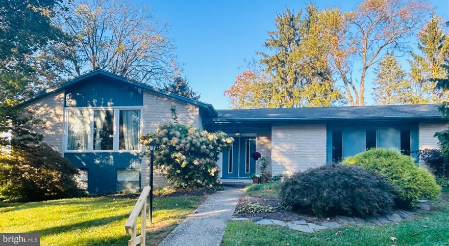 Welcome to 1989 Forest Lane, an over 3,000 square foot, 5 bedroom, 3 bath home on a peaceful culdesac in the Country Downs neighborhood. Built and cherished by the original owners, this home was designed thoughtfully in collaboration with the builder. Enter into the impressive foyer of this split-level home and walk up to the expansive, open-concept living room and dining room. This whole area has the original hardwood floors beneath the carpet. Recently installed plate-glass windows bring abundant natural light into the space. The dining room leads into the large kitchen with a spacious island, modern appliances, many cabinets and two ceiling fans. An addition was built onto the kitchen, consisting of a great room, a bar area and a deck.  Many windows make the space warm and inviting. The great room opens onto the deck, a perfect space to enjoy your morning coffee, read a book, or tend to your plants, since it receives morning and afternoon sun. The living room, dining room, kitchen and kitchen cabinets, great room and primary bedroom were all recently professionally painted and have a fresh, clean look and neutral palette.  The large primary bedroom has hardwood floors and an en-suite bathroom with vanity and walk-in shower. Across the hall is an additional bedroom with hardwood floors. A hallway bathroom completes this level. Downstairs you will find an expansive L-shaped family room with a wood-burning fireplace and large windows. This lower level also boasts 3 large bedrooms and a full bath with double vanity and a walk-in shower. Connected to the foyer you will find a beautiful and inviting screened-in porch, which leads to the back yard. On this level is a convenient laundry room with utility sink and beyond that is a two-car garage with garage door openers and an attic with pull-down steps and flooring.  There is an endless amount of storage available.  The home was built for entertaining and enjoyment and it has many areas for family fun and guests.  An exceptional location in the East Penn School District, just minutes away from Lehigh Valley Hospital, I-78 and 309, many restaurants and shops, but still feels like it's in the country, with surrounding open land and parks. Come see for yourself why this could be the perfect place to call home.