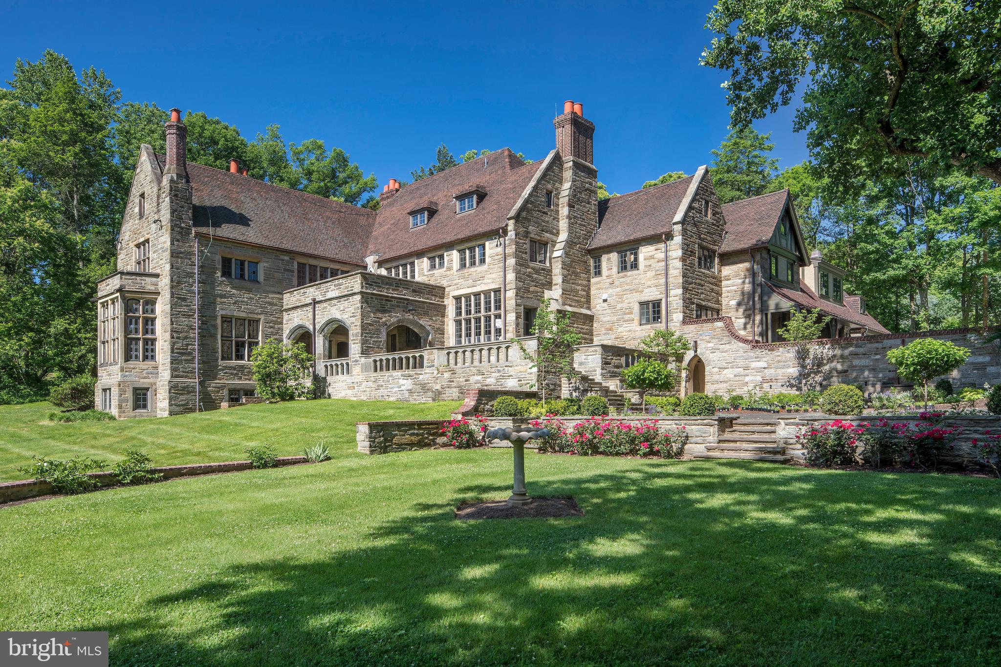 One of Radnor Township's finest estate homes, 365 Conestoga Road blends traditional and modern elements to create an enduring elegance. Built circa 1929 on 2.4 acres in Wayne, the Arts and Crafts-style residence is the design of Bissell & Sinkler, the famed architectural firm of Philadelphia. Purchased by a real estate holding company in 2017, the home is now fully restored, renovated, and modernized; renovations by KingsHaven Properties and staging by KingsHaven Design, completed in 2018. Stunning architectural details and tasteful living spaces illustrate the team's careful restoration practices and passion for creating a 'forever' home to inspire for generations. The result is a rare, complete balance of function and seamless design: it is timeless yet contemporary, grand yet beautifully intimate. Exquisite leaded-glass windows shower the home with natural light; new hand-crafted iron fixtures add continuity and texture; carved limestone fireplaces suggest warmth and welcome; rare chestnut paneling and wide-plank flooring as well as red-clay-tile roof proclaim the home's refined materials and construction; new luxurious amenities and modern improvements (e.g., the state-of-the-art geothermal HVAC system) elevate the home's performance to match its sophisticated grandeur. The Dining Room and Living Room, boasting soaring ceilings, fireplaces, butler's pantry, and dual terrace access, provide excellent indoor/outdoor flow, perfect for occasions of any size or season. The new, eat-in kitchen impresses with custom cabinetry, luxury appliances, and designer lighting to maintain the home's splendor and style, while the adjacent family room, mudroom, elevator, and garage access provide for pleasant everyday living. The remaining first level features two powder rooms and a private office, perfect for working from home. The expansive Master Suite, with surround views of the back lawn and garden, features an adjoining balcony and multiple seating areas; the Master Bath, fashioned with Calacatta marble throughout, includes soaking tub and marble shower; his-and-her custom vanities and walk-in closets complete the tranquil space. The home comprises five (5) additional bedrooms, four (4) full baths, and two (2) powder rooms, including a guest quarters (in-law/au pair suite) equipped with kitchenette, full bath, living room, private exterior entrance, and elevator access. The lower level features spacious media and rec rooms.Adding to the home s exceptional flow, the stone terrace behind the house extends the interior living space and provides a transition between the house and garden, providing views of the sprawling lawn and tree-lined estate. The covered area steps down to an uncovered lower level with arched stone entrances, fountain, and potting shed. On a sunny day with the flowers in bloom, stroll through the home and out the arched doors to experience your own secret garden. The home enjoys close access to both the Radnor Trail and Chanticleer Gardens, as well as major roadways, SEPTA Regional Rail to Center City Philadelphia, some of the most highly regarded private and public schools in the country, and popular dining, shopping, and entertainment options offered in charming downtown Wayne. Conveniently located for travel to New Jersey, New York City, and Washington D.C.