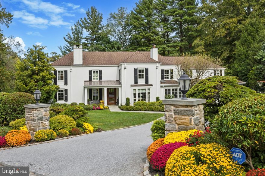 Set along one of North Side Haverford’s most picturesque tree-lined streets in prestigious Lower Merion Township, 543 Avonwood Road is a masterfully updated Colonial that blends timeless Main Line architecture with luxurious modern living. Every inch of this residence has been thoughtfully designed for comfort, sophistication, and effortless entertaining. Originally built with classic Main Line craftsmanship, the home underwent an extensive renovation from 2016 to 2018, reimagined for today’s modern lifestyle while preserving its architectural integrity and charm. Enter through the covered front porch into a welcoming foyer that opens to sunlit, gracefully proportioned interiors enhanced by gleaming hardwood floors, custom millwork, and designer finishes throughout. The gracious living room, centered around a classic wood-burning fireplace, opens to a bright family room with a gas fireplace. The family room flows seamlessly into the formal dining room—perfect for gatherings both intimate and grand. At the heart of the home lies the chef’s kitchen, showcasing a dramatic 10-foot quartzite island, premium stainless-steel appliances, custom cabinetry, and a walk-in pantry. Just off the kitchen, the mudroom offers built-in storage, charging stations, a bench seat, and access to the expanded two-car garage with additional storage. Completing the main level is a handsome den or office featuring custom built-ins and a wood-burning fireplace, along with a stylish powder room off the central hall. Upstairs, the primary suite serves as a true private retreat, featuring a spa-inspired bathroom with a soaking tub and oversized shower, two walk-in closets, and a custom-fitted gym ideal for wellness and relaxation. Two well-sized bedrooms share a full hall bath, while an additional bedroom enjoys its own en suite bath. Off the back staircase, a spacious bedroom and bath provide a perfect guest or au pair suite. A conveniently located laundry room sits just off the primary suite. The finished lower level, complete with custom built-ins, offers versatile living space ideal for a media room, playroom, or home office, along with abundant storage and mechanicals. Outside, the property transforms into a private resort oasis—complete with a heated pool and integrated spa, surrounded by lush landscaping and an expansive stone patio designed for al fresco dining and effortless entertaining. Located within the highly sought-after Lower Merion School District, this exceptional home offers the very best of Main Line living—just moments from Haverford Station, Suburban Square, Merion Cricket Club, and award-winning schools. Combining timeless architecture and a premier location, 543 Avonwood Road is a rare opportunity to own a truly turn-key residence in one of Haverford’s most coveted neighborhoods.