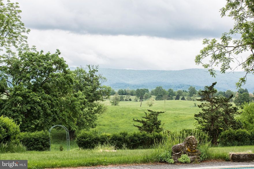 400 acres South of Route 50 in Prime Clarke county. Historic Montana Hall has been a working farm for more than 50 years.  Centrally located in the southern part of the county it is home to multiple animals -- horses, cattle, sheep - fertile crop land, soybeans and corn plus good hay are grown on this farm annually.  Some of the Blue Ridge Hunts best country - all panelled and gate friendly.   Parcel offered includes main house (8,000 sq) attached one bedroom guest house, summer kitchen/guest house, tenant house, 4 car two level garage, kennels, Ice house and historic spring house on Virginia historic registry, two barns,  outbuildings , two ponds, great views. VOF Easement.  Priced below tax assessed value.  Some of the most beautiful views in Clarke County, sweeping pastures and the Blue Ridge Mountains.  In the middle of the Blue Ridge Hunt territory.