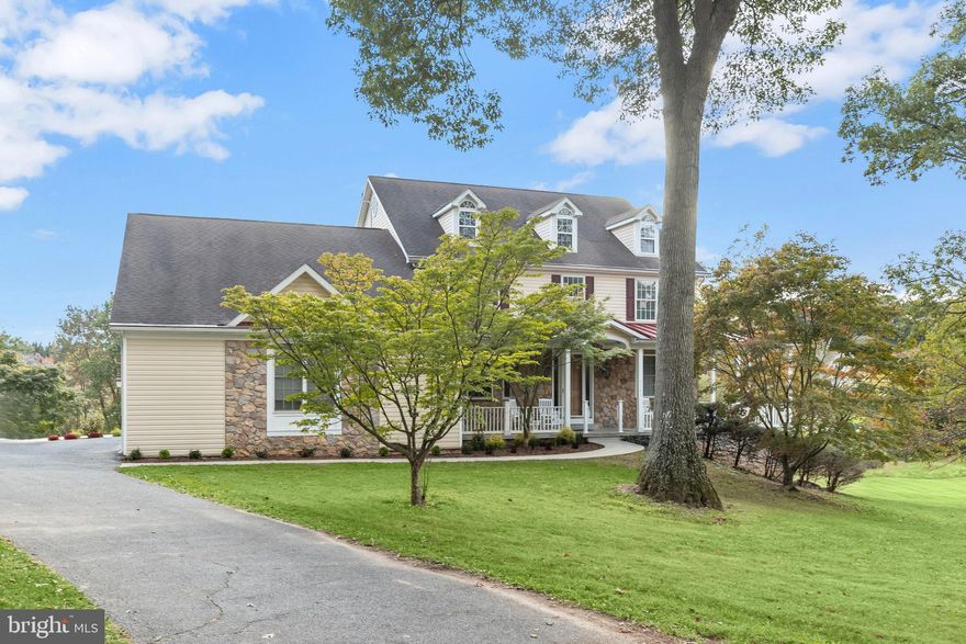 5722 Banjo Drive | Eldersburg, MD | Morgan Estates

A rare offering in prestigious Morgan Estates—this Carrigan Homes Susquehanna model delivers 4,786 sq ft of living space, exceptional multi-suite livability, and a subdividable 6.81-acre premium corner lot backing to trees and a creek. With new paint (2025), new carpet (2025), and new 3-car garage doors (2025), this residence blends timeless craftsmanship with thoughtful modern updates.

Step inside the impressive two-story foyer, framed by an 8-ft entry door and an electric chandelier lift, leading into a main level designed for both elegance and functionality. Rich hardwood floors span the entire main level, where a dual staircase (front and side entry) enhances convenience and architectural appeal.

A refined dining room with a bay window and pocket doors flows gracefully into the expansive family room, anchored by a stone, double-sided gas fireplace shared with the gourmet kitchen. The family room offers two sets of French/atrium doors opening to the TREX rear deck, creating seamless indoor-outdoor living.

The chef’s kitchen is the heart of the home—featuring a wrap-around island and breakfast bar, professional-grade stainless appliances including Sub-Zero refrigeration and Decor gas cooking, and a generous walk-in pantry. A cozy breakfast room with its own gas fireplace opens to the screened dining porch, ideal for peaceful morning coffee or alfresco evenings.

Enjoy true main-level living with a spacious primary suite, a main-level laundry center, and both a full and half bath on this floor. A private study with pocket doors to the foyer and atrium doors to the side porch offers an elegant work-from-home retreat. A large mud room with secondary entry access connects to the laundry, perfect for daily functionality.

The upper level hosts four bedrooms, including a second primary en-suite over the garage—ideal for multi-generational living, guests, or extended family.

The walk-out lower level (remodeled 2025) provides an exceptional private au-pair suite with separate entrance, a recreation room, full bath, and expansive unfinished storage with walk-out access—ready for future customization.

Outside, the property shines with a wrap-around covered porch, stone front elevation, stone accents on all four sides, gas front lanterns, TREX decking, and a charming shed/playhouse. The acreage offers privacy, picturesque views, and the invaluable potential of subdivision—an extremely rare opportunity in this location.  Come home to luxury living with endless lifestyle options!