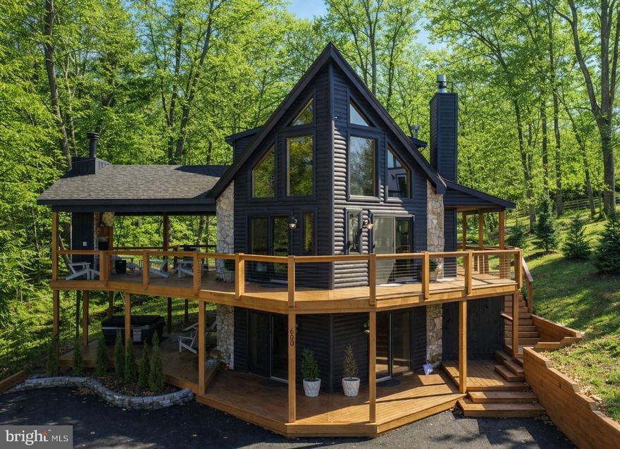 Welcome to 660 Glendale Road — a luxury, mountain-chalet log home in the heart of Deep Creek Lake. This well appointed 5-bedroom, 3-bath home offers nearly 2,600 square feet of thoughtfully upgraded living space designed for lake life at its best. Enjoy lake views with western exposure on the expansive wraparound decks on main and lower levels. Many recent upgrades including roof, decks, covered porch, hot tub, retaining walls, furnace, countertops, appliances, flooring, paint, bathrooms, and much more. The open-concept main level features a spacious great room with abundant natural light, cozy fireplace, and seamless flow to the kitchen.  Enjoy multiple living areas inside and out, providing plenty of room to expand and embrace time at the lake. Highlights include upgraded interior finishes throughout, private primary suite with balcony and creek views, covered deck with wood burning fireplace and a lower-level game room, four total fireplaces and only a short drive to local dining and the lake's most desirable attractions. Enjoy access to the lake at the Deep Creek State Park only a mile away or at one of the nearby marinas. No HOA! If you would like to discuss this home further or schedule a private showing, call today!