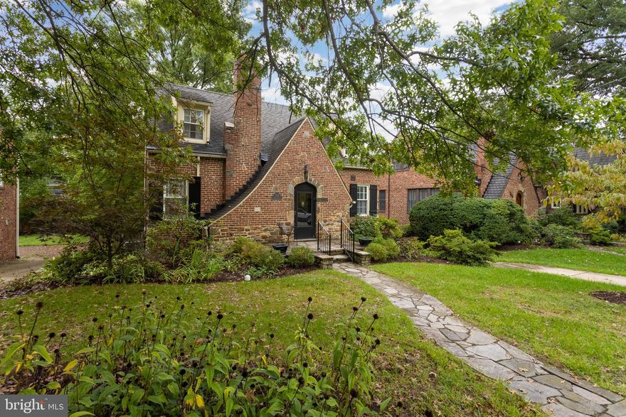 Charming Storybook Tudor Revival Home in the Heart of Anneslie!
Welcome to 718 Anneslie Road, a stunning brick Storybook Tudor Revival in the highly sought-after Anneslie neighborhood. This storybook home exudes timeless charm with its beautiful architecture and modern updates, offering a perfect blend of elegance and comfort.
As you approach, you’ll be captivated by the classic swooping roofline, complemented by striking black doors and shutters. The original stone walkway leads to a cozy front porch, providing a welcoming entry that invites you inside.
Step into the front vestibule, where a convenient coat closet awaits. The formal living room features gorgeous original hardwood floors and a Napoleon wood-burning fireplace with a rustic stone mantel, perfect for cozy evenings. The space is flooded with natural light, creating a warm and inviting atmosphere.
The adjacent dining room, with hardwood flooring, offers ample family gatherings and entertaining space. Just off the dining room, the updated kitchen boasts custom oak cabinetry, providing plentiful storage and counter space. While the appliances are classic white, a stainless steel dishwasher adds a touch of modern convenience.
Step out to the screened-in porch through the kitchen—an ideal spot for enjoying your morning coffee or relaxing with a book. This space overlooks the beautiful stone patio and backyard, shaded by a mature tree and framed by a brick retaining wall, offering a peaceful retreat for outdoor living and entertaining.