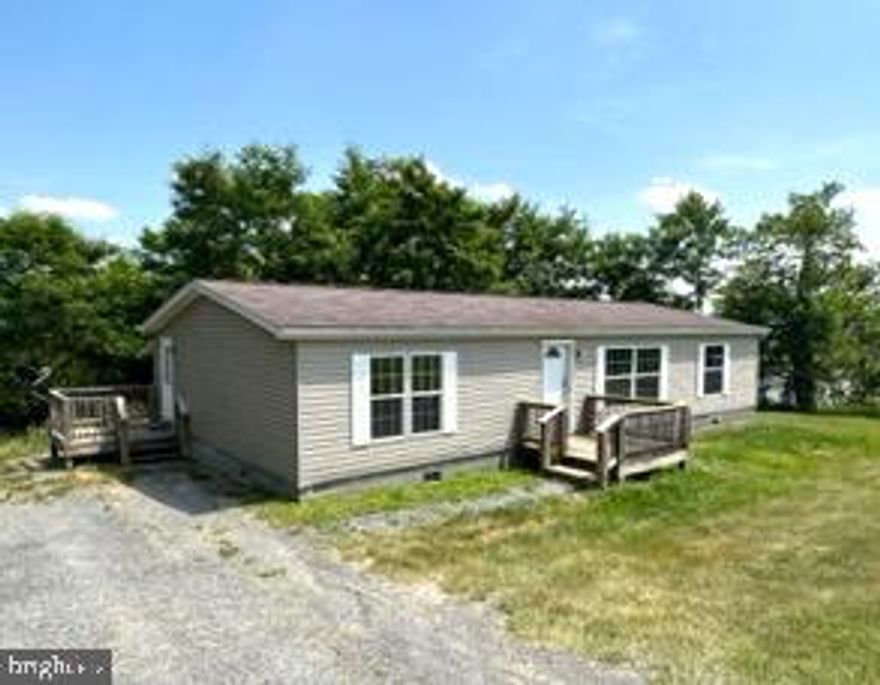 ATTRACTIVE 3 BEDROOM, 2 FULL BATH DOUBLEWIDE ON 2.44 ACRES OF UNRESTRICTED LAND. EXTERIOR INCLUDES FRONT AND SIDE DECKS (, VINYL SIDING, SHINGLE ROOF, NEW DOUBLE PANE VINYL REPLACEMENT WINDOWS THRU OUT AND LARGE 7-CAR GRAVEL DRIVEWAY.  LIKE-NEW INTERIOR OFFERS NEW CARPETING THRU OUT,  KITCHEN W/ ALL APPLIANCES, BREAKFAST BAR/ISLAND, OAK CABINETS SLOPPED CEILING AND LINOLEUM FLOORING.  LIVING ROOM W CEILING FAN/LIGHT, SLOPPED CEILING, SIDE BY SIDE WINDOWS AND W-W CARPETING. SEPARATE DINING ROOM W CHANDELIER, BUILT-IN CABINETS & LINOLEUM FLOORS. LAUNDRY ROOM W DRYER HOOKUP AND SIDE DOOR LEADING TO DECK.  MASTER BEDROOM W CARPETING, 4 X 6 CLOSET & WALK THRU MASTER BATH W CORNER SHOWER.  2 GUEST BEDROOMS W LARGE CLOSETS AND CARPETING.  FULL BATH W TUB-SHOWER COMBO & LINOLEUM FLOORING.  OTHER AMENITIES: HEAT PUMP, CENTRAL AIR, PEX-PLUMBING, FRESHLY PAINTED THRU OUT, PUBLIC WATER, SEPTIC TANK AND ROOM TO EXPAND.  THIS HOME IS READY TO MOVE INTO - ALL THE WORK IS DONE!!! CALL FOR AN APPOINTMENT TODAY TO VIEW, YOU WON’T REGRET IT