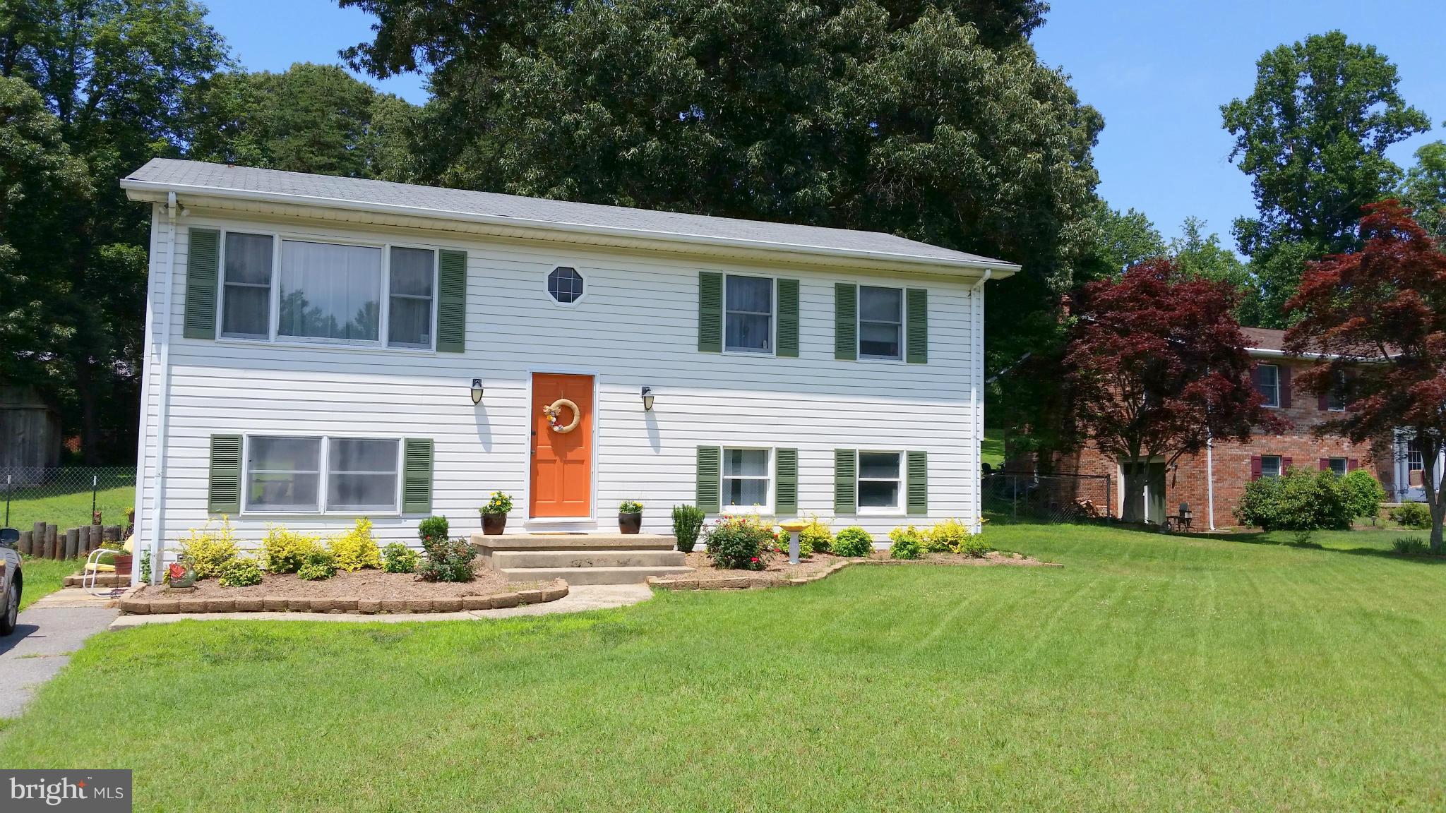 Lovingly kept split foyer with 4 bedrooms, 2 full baths. Large open kitchen/dining leading to deck overlooking the fenced backyard. The finished basement includes a family room with barn wood trim, a 4th bedroom and an office area as well as a laundry room with tons of storage. House sits on corner lot of almost a half acre. Plenty of parking and a voluntary HOA for beach access.