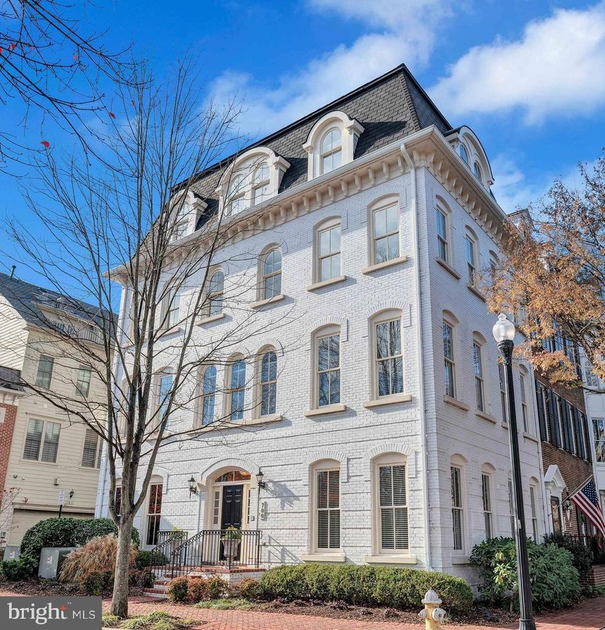 Commanding the prime corners of Rose Square and Carpenter Road, this striking white brick townhome is one of the most prominent homes in the neighborhood. A rare Congressional model by Craftmark Homes, it seamlessly blends luxury with functionality. With windows on three sides, the residence is bathed in natural light, creating a bright and welcoming atmosphere.

Featuring four bedrooms, including two expansive owners' suites, this home is designed to accommodate a variety of living arrangements with style and grace.
The entry-level offers a spacious recreation room complete with a wet bar, perfect for entertaining or creating a cozy retreat.


The open floor plan on the main level is anchored by a double-sided gas fireplace that connects the family and dining rooms. At the heart of the home, the gourmet kitchen boasts an oversized island with built-in wine racks and a new wine refrigerator, stainless steel appliances, double ovens, and a modern dishwasher. Refinished hardwood floors, recessed lighting, hardwired speakers, and custom window treatments add to the home’s refined ambiance.


The third floor includes the first owners' suite, featuring two closets and an en-suite bath with dual sinks, a soaking tub, and a separate shower. Two additional bedrooms and a guest bath complete this level.

The entire top floor is dedicated to the second owners' suite, a private retreat offering a sitting area, a spa-like en-suite bath with granite countertops, dual vanities, a soaking tub, and a shower with body jets. Both owners' suites include spacious walk-in closets.

Panoramic views of Rose Square, wetlands, and seasonal glimpses of Dangerfield Island and the marina.
A side-entry, two-car garage enhances privacy and convenience.

The Potomac Greens community epitomizes luxury living, offering nature walking trails, brick-paved sidewalks, a clubhouse with a meeting/party room, a fitness center, an outdoor heated pool, pocket parks, and tot lots.

Centrally located, this property is near Amazon HQ2, the Virginia Tech Innovation Campus, and the Potomac Yard Metro, placing you at the forefront of progress and innovation. It’s also just minutes from the historic Old Town waterfront, the vibrant Del Ray neighborhood, and the George Washington Parkway, with access to the renowned Mount Vernon bike trail. Commuting is effortless with proximity to I-495, I-395, I-95, Reagan National Airport, and downtown Washington, D.C., just two traffic lights away.

 Discover a lifestyle defined by elegance, convenience, and unrivaled luxury.