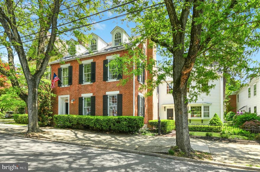 On one of Historic Bethlehem’s most admired tree-lined streets, stands this mid‑1800s home. Wrought‑iron gates frame a quaint courtyard garden leading you to the entry and into an exquisite interior. 
    The main level was re‑imagined by the current owners to create an open, flowing floor plan, where detailed appointments and lovely moldings complement a magazine‑worthy custom kitchen with extensive built‑ins, high‑end appliances, and an inviting breakfast room.
     Offering approximately 5,400 square feet on four floors, the layout includes five bedrooms, a separate guest wing ideal for family or visitors and - a rare find in Historic Bethlehem – a finished basement. On the main level, a comfortable family room with French doors to the gardens connects seamlessly to the living room with fireplace and formal dining room beyond, while a first‑floor office with its own fireplace provides a quiet retreat. The primary bedroom suite, redone with panache, will take your breath away.
      Outside, a professionally landscaped, private English garden with paver patio, stone walls and specimen plantings, leads to a two‑car garage with third work bay and, a rare feature, additional off‑street parking.