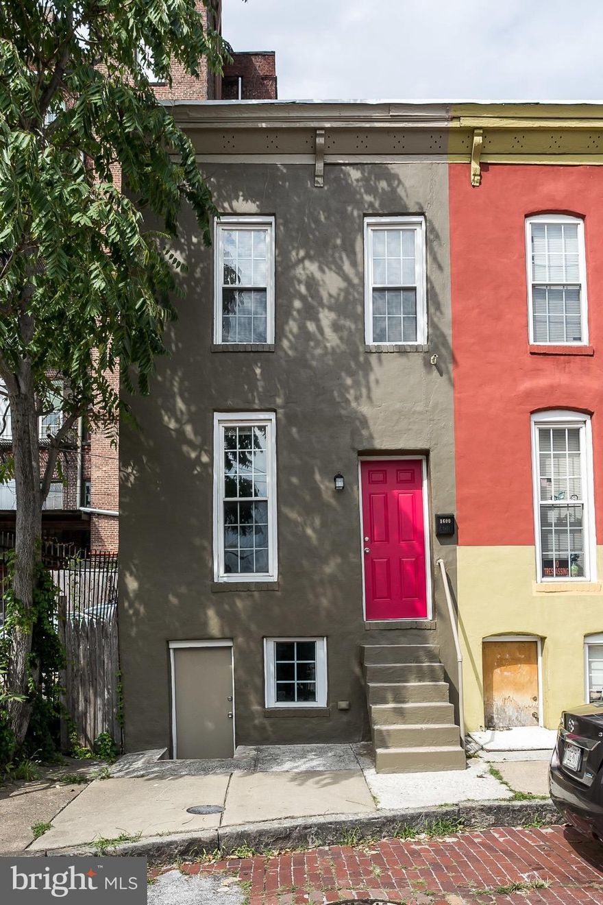 Cutest, most colorful street in Greenmount West! Tiny House with big impact! Modern, open floor plan home with new kitchen, laundry room upstairs and bonus space below with separate front entrance - artist studio, bike storage?  Own for less than renting!! Parking avail for $25 month across from your front door!
