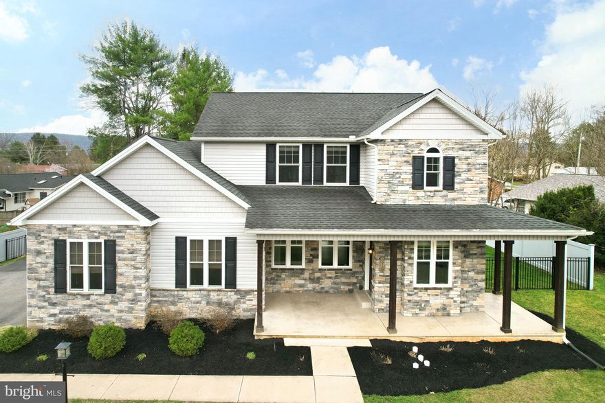 This stunning, move-in-ready residence in the State College Borough blends contemporary sophistication with a thoughtful, open floor plan. From the charming covered front porch, step into a sun-drenched main level featuring rich hardwood floors and designer finishes throughout. The heart of the home is the expansive family room, anchored by a sleek electric fireplace - the perfect centerpiece for cozy evenings. Flow effortlessly into the gourmet kitchen, a chef’s dream boasting ample cabinetry, a large center island with pendant lighting, stainless steel appliances, and a classic subway tile backsplash. The adjacent dining area opens through oversized glass doors to a private, fenced-in yard designed for entertaining, featuring a concrete patio covered by a stylish white pergola. A convenient laundry room and half bathroom round out the main floor. The upper level features two secondary bedrooms, a full bath, and a primary suite that serves as a true sanctuary. The primary bedroom offers a large walk-in closet and a barn-door entry into a stunning en suite bathroom complete with a tiled standing shower and a deep, freestanding soaking tub. Additional living space awaits in the finished lower level, providing the perfect footprint for a home theater, gym, or play area. Location is everything, enjoy unparalleled access to the best of Happy Valley, including local dining and shopping in Downtown State College, Beaver Stadium, and Centre Hills Country Club. Experience the perfect blend of modern luxury and Borough convenience. Schedule your private tour today! *Listing agent is related to seller.