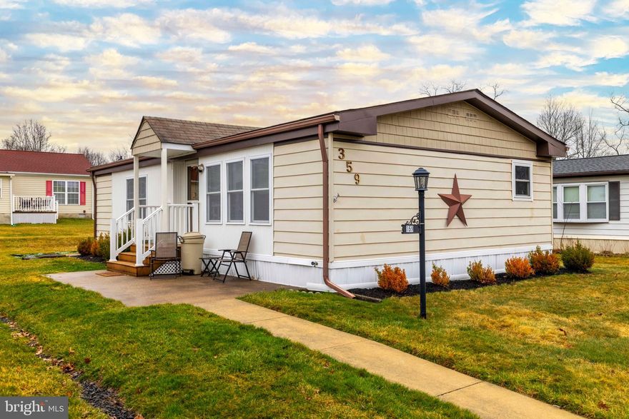 Welcome to this well-maintained double-wide mobile home located in the highly desirable 55+ community of Neshaminy Falls in North Wales. Offering 2 bedrooms and 2 full bathrooms, this home combines comfort, convenience, and recent updates throughout. Step inside to find a freshly painted interior in modern grey and white tones, complemented by new flooring and new carpeting. The spacious living room flows seamlessly into the dining area, featuring an overhead fan and easy access to the screened-in porch—perfect for relaxing or entertaining. A front patio adds additional outdoor space to enjoy. The kitchen is equipped with a breakfast bar, pantry storage, and includes a stove/oven and refrigerator, while offering pleasant views outside. Just off the hallway, you’ll find a guest bathroom with a stall shower, along with a dedicated laundry area complete with washer, dryer, and storage. The primary bedroom is generously sized, featuring a ceiling fan, ample closet space, and a private 3-piece en-suite bathroom with vanity and stall shower. A second bedroom, also with a ceiling fan, is ideal for guests or additional living space. Additional highlights include a newer water heater, shared two-car parking just steps from the home, and thoughtfully maintained landscaping. Residents of Neshaminy Falls enjoy a low-maintenance lifestyle, with monthly lot rent covering access to the clubhouse, community activities, heated pool, and common area maintenance.
A comfortable and move-in ready home in a vibrant community—schedule your tour soon.