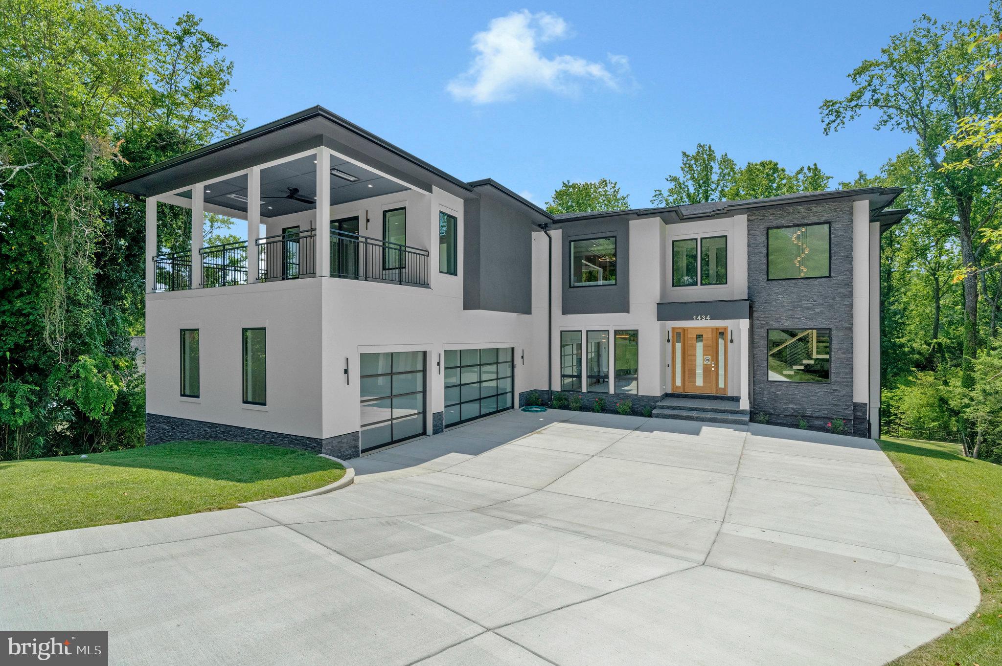 Call Alternate/Co List Agent. Modern elegance meets resort-style living in this architecturally striking residence, nestled on a quiet 31,533 sq ft lot in the heart of McLean. The home features a sleek stucco façade, expansive glass windows and doors, and a spacious three-car garage that create outstanding curb appeal. Backing to a tranquil creek and wooded views, the property offers exceptional privacy and a serene natural setting.Inside, 10-foot ceilings on all levels create an airy and open atmosphere. High-end finishes include 10” wide prefinished oak hardwood flooring, solid 8-foot modern doors, and exotic designer light fixtures. The open floor plan flows into a dramatic family room with a floor-to-ceiling linear gas fireplace and a large screened porch with metal-framed screens, and a gas fireplace—perfect for entertaining year-round.
The primary suite is your personal sanctuary, featuring a Juliet balcony, its own gas fireplace, and a private terrace that overlooks the scenic backyard. A charming Juliet balcony opens to serene views of the backyard and woods—an ideal spot to enjoy a quiet morning with a cup of tea or unwind in the evening with a good book. A sleek gas fireplace adds warmth and ambiance, creating a cozy atmosphere year-round.The ensuite bathroom is a statement of modern luxury, featuring heated floors that provide ultimate comfort on cooler mornings. All additional bedrooms on the upper level are ensuite, offering comfort and privacy for family members or guests. Each room is generously sized and thoughtfully appointed with custom walk-in closets, marble-topped vanities, and beautifully tiled bathrooms that reflect timeless elegance and quality craftsmanship.
The lower level is a seamless extension of the home’s luxurious feel, thoughtfully designed for both entertainment and everyday living. At its center is the expansive recreation room, featuring a custom wet bar with designer finishes, a cozy stone fireplace. Rich wood paneling and ambient lighting elevate the space, giving it a warm, inviting ambiance.This level also includes a state-of-the-art media room with tiered seating, offering a true cinematic experience, and a dedicated exercise room with direct access to a full bathroom—making it ideal for a post-workout refresh or potential guest suite. Whether you're entertaining, relaxing, or staying active, this lower level delivers the perfect blend of luxury and livability. Located minutes from downtown McLean, top-rated schools, shopping, dining, and commuter routes, this home offers luxury, comfort, and convenience all in one.