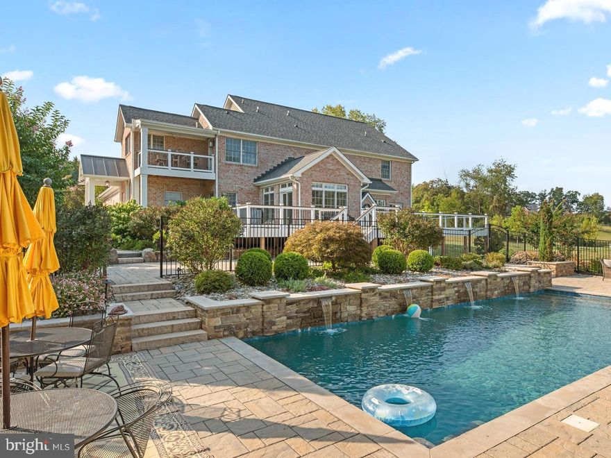 Yes- your dream home does exist...and it's right here nestled on 2.27 acres of serene landscape! This stunning all-brick Colonial home features 5 bedrooms, 4 full baths, and a half bath on the main level. If you're looking for a bit of privacy but don't want to be isolated, Branch Hill Estates is the perfect balance, offering an impressive neighborhood surrounded by the beautiful Ag Reserve. Custom-built home in 2001 with a newly built heated saltwater pool & pavilion (2022), creating a true resort-style retreat designed for relaxation and effortless entertaining. Just under 4600 finished sqft of living space, this property features a 3-car attached garage and outdoor amenities that'll blow you AWAY!
Hardwood floors throughout the main and upper levels. This well-appointed home faces NW, providing sunrises in the back of the house and sunsets from the front porch. The center hall welcomes you to the living room with a gas fireplace and an elegant dining room. The gourmet kitchen features stainless steel appliances, granite countertops, a pantry, a gas range that vents outside, and a second oven in the island. It opens effortlessly to the family room with a cozy gas fireplace and a light-filled morning room wrapped in windows. From here, step out to the oversized Trex deck overlooking the expansive grounds—complete with a saltwater hot tub for year-round relaxation.  Back inside, a private home office is thoughtfully tucked away at the rear of the home—perfect for work, study, or even as a main-level bedroom. The adjoining powder room has some connections in place for a shower, offering an option to convert it into a full bath. The mudroom includes laundry and a side entrance for everyday convenience. 
Ascend the wood staircase to the second level, where the primary suite awaits with picturesque views of the pool. Step out onto the private owner’s deck—complete with blinds—creating a peaceful escape. The ensuite bath offers a soaking tub, shower with a bench, and two walk-in closets. A hidden bonus is the expansive, ready-to-finish space above the garage, ideal for future customization. The versatile fifth bedroom connects to both the hall and the primary suite, making it perfect as a nursery, second office, project room, or even a dream walk-in closet. Three additional generously-sized bedrooms with a hall full bath and a Jack & Jill style bath between the 3rd & 4th bedroom. Yes- 3 full baths upstairs. 
Downstairs, the walkout daylight basement features a rec room and full bath, perfect for guests or a quick rinse off after a swim. Plus a huge, spacious workshop/gym and tons of storage! Just beyond the doors, your backyard oasis unfolds with a 25,000-gallon saltwater pool and pavilion with landscape lighting, offering endless fun and relaxation throughout the day and night! 
For added peace of mind, the sellers recently tested the well water (May 2025), radon test completed (May 2025), and the septic system was inspected and pumped (April 2025), receipts available.
Impressive recent upgrades include: New water heater (2024). New roof (2023). Pavilion with a full masonry fireplace (2023). Dual zone; both units replaced (2023), whole house humidifier (2023), Trex deck (2022). A fenced-in pool with custom cover was installed by Browning (2022). The pool app controls the waterfalls, filters, and water temperatures. Programmed ground lighting with a timer. Main level Anderson glass sliding doors (2018). Surge protector and whole-house generator 22KW (2014) w/ a 500 gal. dedicated propane tank, maintained & serviced twice a year by Tower Power. 
This extraordinary property combines luxury, comfort, and breathtaking outdoor enjoyment!