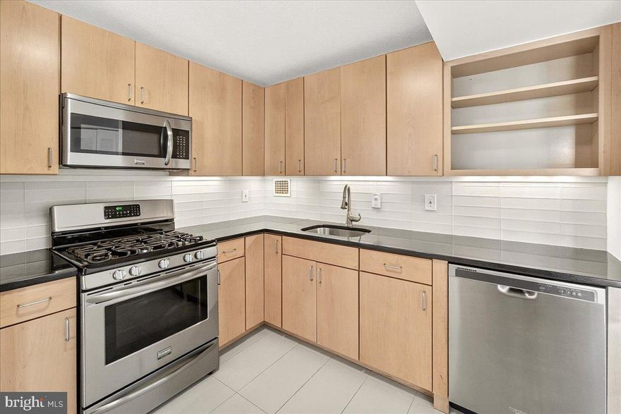 Move-in ready 1BR condo with garage parking at Americana Centre! Bright open layout with new flooring, fresh paint, and a private balcony. Updated kitchen features stainless steel appliances, gas range, granite counters, and ample cabinet space. Spacious bedroom includes a walk-in closet and room for a desk or reading nook. Clean bath with tiled tub/shower combo and vanity. Amenities include pool, sauna, fitness center, grills, 24-hr front desk, renovated lobby, laundry on each floor, free storage units (waitlist), and condo fee covering all utilities. Steps to Rockville Town Center, Metro, dining, shopping, and parks, with easy access to I-270 and DC.