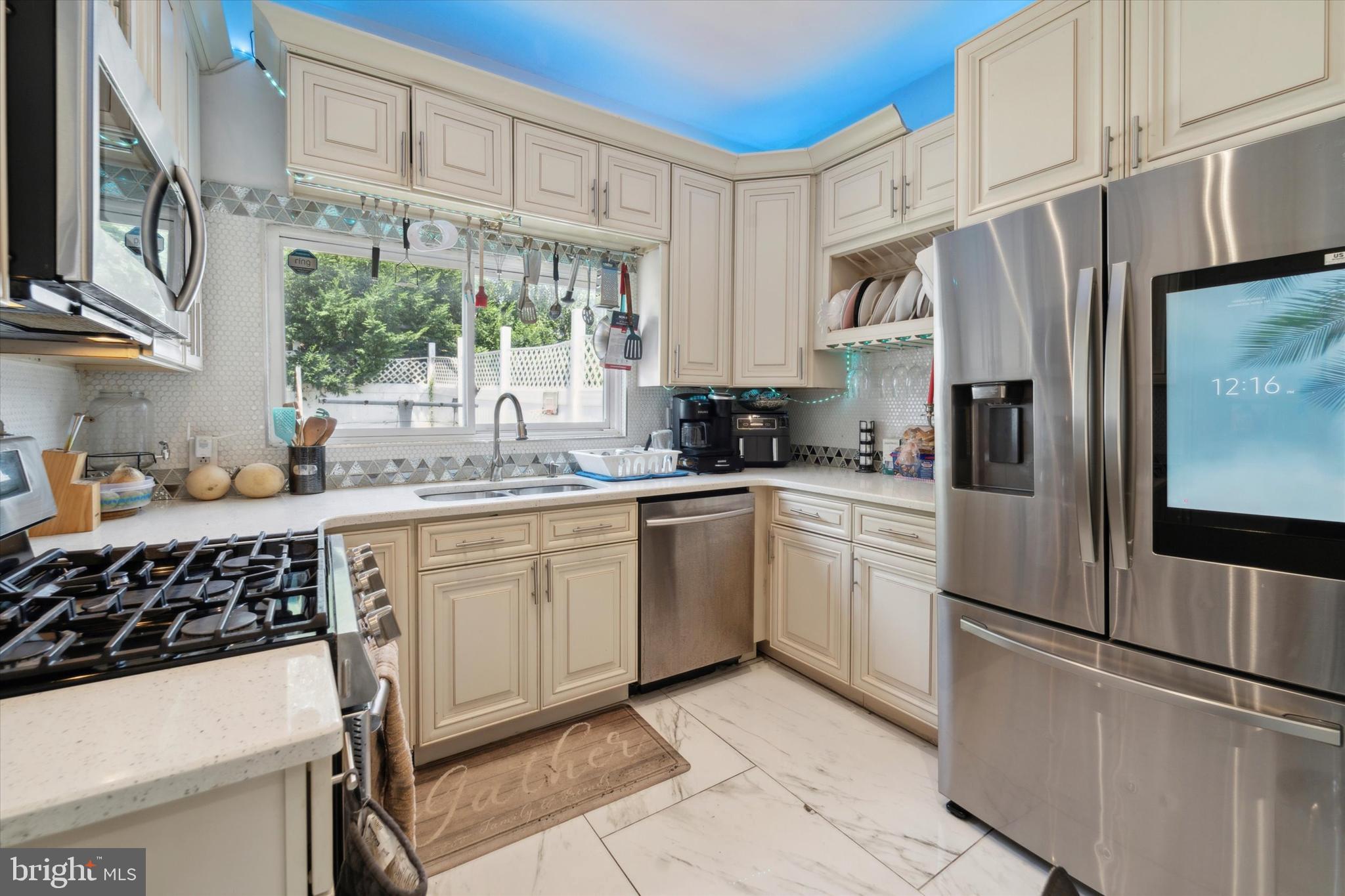 This is a house like no other in the area! Situation on an 86 foot lot, this house boasts almost 1500sf of living space and a gigantic backyard!! Completely remodeled just 5 years ago, this home has all the bells and whistles- from crown molding with LED accent lighting to gourmet kitchen. You won't find anything like this at this price point in Philly! Enter into to the open floor plan first floor with gleaming tile floors, recessed lighting, ornate time, and stacked stone accents. This extra long floor has plenty of room for living room, office area, dining room, and kitchen. The kitchen features cream cabinetry, with quartz countertops, and state-of-the-art appliances. From the kitchen you can enter in to the large side storage area- a unique feature of this house!- which is also accessed through a second front door on the street. This is a great space for a contractor to store tools, or to store bikes, motorcycles or more. This also leads out to the rear yard, which provides an abundance of space and land for gardening, parties, play areas, or pets. A set of stairs leads up to additional outdoor living space: a fiberglass deck that is also accessed from the second floor. On the second floor, you'll find wood floors and three large bedrooms with generous closet space. The gorgeous full bathroom features marble mosaic tiles, glass shower with bench, storage and more and is tiled all the way to the ceiling. Come see this property today and invest in this growing neighborhood!