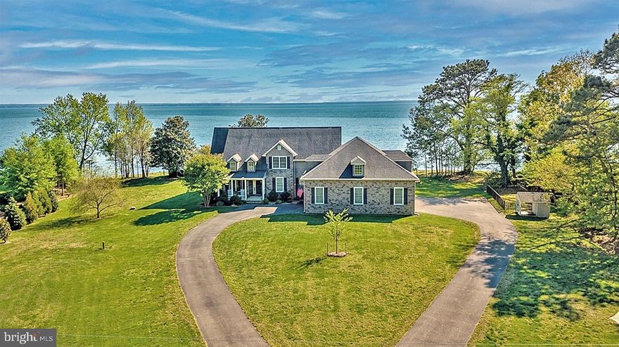Coming Soon: Welcome to a rarely available colonial riverfront retreat. With 215' of newly pointed stone bulkhead, your boating, fishing, and crabbing desires will be easily met. The 72' dock with a 10,000 lb lift centers the property as you gaze across the widest part of the Potomac River.

Once the site of a historic lodge used by the DC elite, this grand colonial boasts an energy-efficient geothermal HVAC system (which earns quarterly cash dividends), a propane gas fireplace with a wood-carved facade, and a copper- and brick-surrounded six-burner gas stove with a griddle and double ovens. The home also features a home office with custom bookshelves and file cabinets, as well as a formal dining room with historic wainscoting from the former lodge.

Enjoy the first-floor primary bedroom with its adjoining walk-in marble shower, jetted tub, and massive walk-in closet. The favorite room, of course, is the expansive all-season sunroom where you can take in all that nature has to offer: the ever-changing wind and waves, osprey, blue heron, eagles, and magnificent sunsets.

Choose one of two staircases—one equipped with an Acorn stairlift—to find four large bedrooms, all with spacious closets, and two full baths on the second floor. The views from here will keep you entranced. Back on the first floor, find your way through the 20-foot-long laundry/pantry room to the three-bay, five-car garage, which includes a drive-through bay, storage, a shop area, and an Ameriglide Hercules commercial push-button platform lift.

Outside, relax on the paver patio or follow it around to the Amish-built screen house with a brass weathervane atop. Additional features include a Generac generator, a buried 500-gallon propane tank, an encapsulated crawl space with an Aprilaire dehumidifier, a two-room dog house with a fenced dog run, and an 18 x 40 pole barn. Standing at the street, take in the stately old trees and the view of the river on either side of the stone-faced house; you will know this is what you’ve been looking for.

The property is just minutes from the Swan Point Yacht and Country Club for championship golf and fine dining, or a short drive to the Waterman's community of Cobb Island, which offers your choice of several restaurants and a handy market. Ronald Reagan Airport (DCA) to the north and historic Fredericksburg to the west are both only 40 miles away.