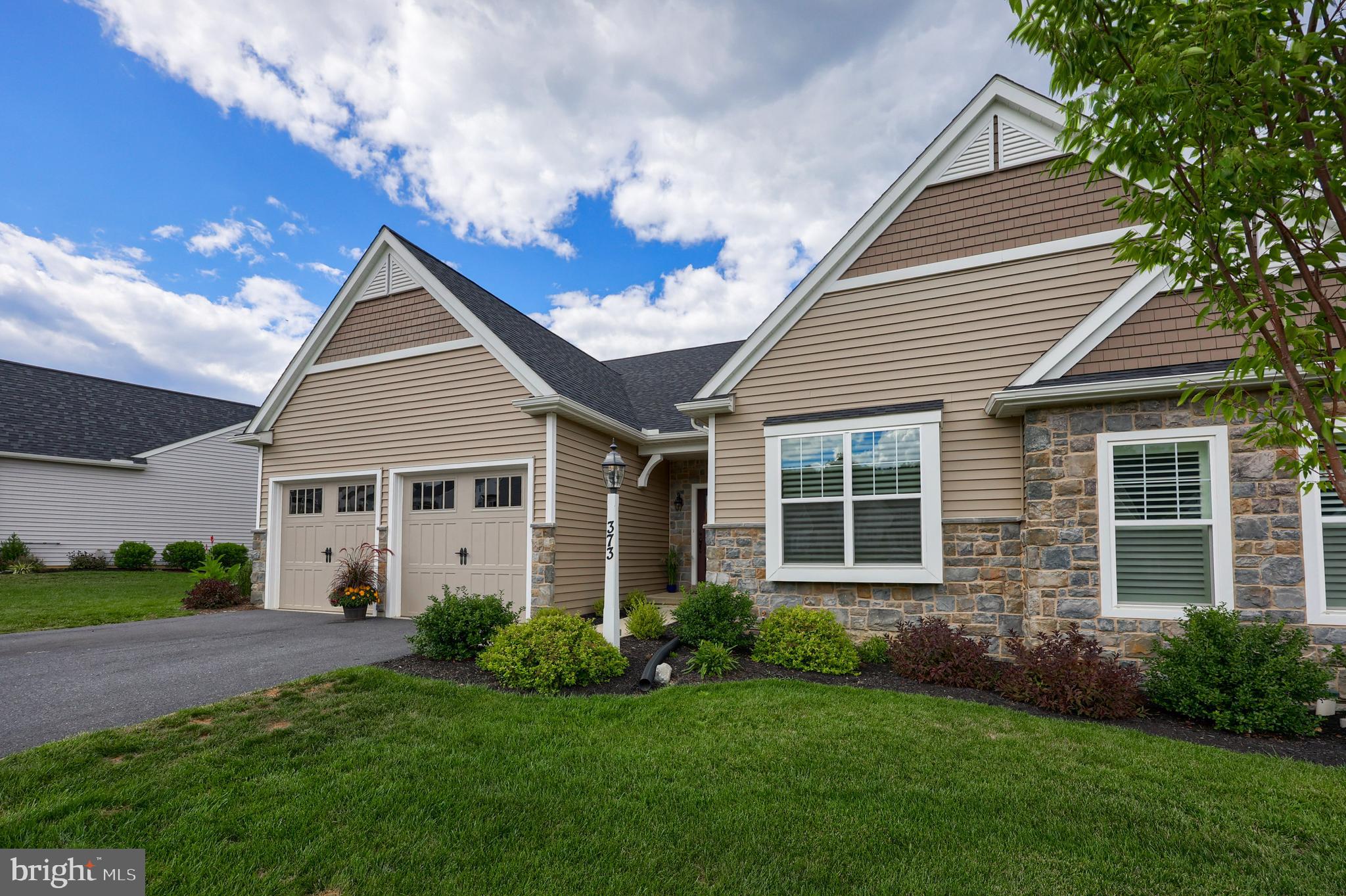 Welcome to 373 Autumn Harvest Lane, situated in the desirable Warwick Crossing development in Warwick Township. Carefree living awaits you in this 2 bedroom, 2 full bath, one story home that has been meticulously maintained and cared for and offers many upgrades throughout. Enjoy preparing meals and entertaining in the spacious kitchen with quartz countertops, upgraded kitchen cabinets, tile backsplash, and a center island where everyone can gather around. Relax in the large Living Room with the cozy floor to ceiling drystack stone gas fireplace, radiating warmth and ambiance on those cold winter nights. The Owner's Bedroom offers a peaceful retreat including a private bath with a tile shower and porcelain ceramic tile flooring, as well as a spacious walk-in closet. Enjoy the rest of the one floor living areas including a second bedroom (currently being used as a sitting room with a pull out couch), study, laundry room and pantry. Rounding out the inside features, you will find engineered hardwood floors throughout most of the home and a full basement with superior walls waiting to be finished to provide additional living space. Step out the back of the house to an invitng screened in porch which leads to a stone paver patio. There are only a few building lots still available in Warwick Crossing, and this home cannot be duplicated at this price if you were to build it new. Why wait several months for construction when this home is move-in ready. Set up you showing today and experience the carefree living that Warwick Crossing provides.