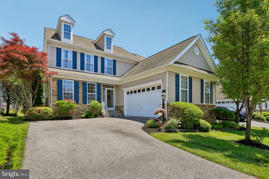 303 Master Derby Drive is more than a home; it is a private waterfront retreat nestled within the prestigious gated community of Bulle Rock, Harford County’s most sought-after luxury destination. Perfectly positioned on a premium lot backing directly to the tranquil pond, this exceptional residence offers approximately 5,000 square feet of beautifully finished living space, combining elegance, comfort, and resort-style living with breathtaking water views throughout.

From the moment you enter the dramatic two-story foyer, you are welcomed by an abundance of natural light, soaring ceilings, rich hardwood flooring, and an open, flowing floor plan designed for both grand entertaining and everyday luxury. The formal living and dining areas seamlessly transition into the expansive family room featuring a cozy gas fireplace, transom windows, and stunning panoramic views of the pond.

The gourmet kitchen is the heart of the home, thoughtfully designed with an oversized counter bar, pantry, breakfast nook/sunroom, and upgraded stainless steel appliances, including a French door refrigerator, gas cooktop, double convection wall ovens, dishwasher, and new microwave. Just beyond, glass doors open to a spacious deck overlooking the water ... the perfect setting for morning coffee, evening wine, or unforgettable outdoor entertaining.

One of the home’s most remarkable features is the luxurious main-level primary suite, offering true main-floor living with a private sitting area/sunroom overlooking the pond, creating a peaceful sanctuary unlike anything else in the community. The suite is complemented by a spacious bath and generous closet space. Upstairs, a second primary suite offers exceptional flexibility for multigenerational living or extended guest accommodations, along with two additional bedrooms, two full baths, and a versatile loft ideal for an office, reading nook, or lounge.

The fully finished lower level is truly an entertainer’s dream. Designed with versatility and comfort in mind, it features a media room/man cave, expansive recreation areas, game table space, a large bar and kitchenette complete with sink, mini refrigerator, and two-burner electric cooktop, plus a fifth bedroom and full bath — ideal for guests or an au pair suite. Additional highlights include a private office with French doors, built-in bookshelves and recessed lighting, a dedicated craft room, and extensive storage space.

Step outside and experience the beauty of the meticulously manicured grounds enhanced by extensive hardscaping, a charming koi pond with a fountain, and a unique greenhouse-covered entrance to the lower-level stairs. Every detail of the exterior has been carefully curated to create a private outdoor oasis that blends beautifully with the surrounding water views.

Located within the exclusive gated community of Bulle Rock, with 24-hour security and world-class amenities, residents enjoy a lifestyle second to none, including golf, pools, clubhouse amenities, fitness facilities, walking trails, and more.

Rarely does a home offer this combination of luxury, flexibility, waterfront serenity, and prestigious community living. 303 Master Derby Drive is a truly extraordinary opportunity to own one of Bulle Rock’s finest pond-front properties.