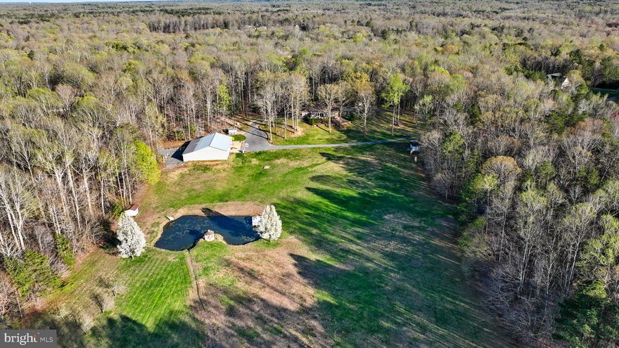 This stunning and beautifully maintained Rambler sits on 17 picturesque acres, offering a rare opportunity for those seeking space, serenity, and unlimited potential. Whether you're envisioning a small vineyard, an events or wedding venue, a horse farm, farmette, or a thriving home-based business, this property is ready to accommodate your vision. The home features a well-designed floorplan, an attached 2-car garage, a bright sunroom, and a stunning outdoor kitchen and patio area with breathtaking views of the pond, complete with a charming gazebo and deck—ideal for entertaining or unwinding in nature. One of the standout features is the expansive 3,500 sq ft detached garage. It includes multiple areas, radiant floor heating, a full bath, a large bar area, and a motorcoach garage with hookups—perfect for car enthusiasts, collectors, or anyone needing serious storage and workspace. There's also excellent potential to convert part of the space into a private in-law suite or apartment with its own entrance. A circular paved driveway and ample parking make the property ideal for hosting weddings, parties, events, or clients—seamlessly blending function with elegance. With room to store tools, equipment, and vehicles, the land supports countless uses, from farming to entertaining. Whether you’re looking for a peaceful retreat, a hobby farm, or a flexible property to launch your next chapter, this estate offers it all. Don’t miss your chance to own this one-of-a-kind property—be sure to check out the video tour of this peaceful and private haven!