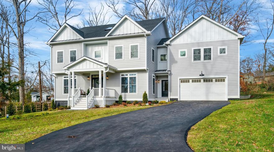 Gorgeous new construction home sits on a half-acre lot and is nestled among mature trees in the beloved NOVA Fort Hunt community in the sought after Waynewood Elementary School District. With over 5,000 square feet of above-grade living space, this one-of-a-kind home offers classic architectural features, lots of upgrades and a fantastic layout. Entering the home through the welcoming covered front porch you will immediately appreciate the beautiful wide-plank hardwood floors, 9 ft ceilings, oversized windows, and open airy feeling. On the right is an office (can easily convert to a formal dining room). On the left is a main floor bedroom with a full ensuite to keep your guests happy in their own private area. As you pass the beautiful staircase, you enter a light-filled expansive kitchen/dining/family room area with a large gas burning fireplace flanked by built-in bookshelves. The oversized sliding glass doors of the family room provide lovely views of the tree-lined backyard. The kitchen features white shaker painted maple cabinets, quartz countertops, tiled backsplash, large farmhouse sink, large island with seating for 4 and plenty of storage. Immediately off the kitchen, you will find a powder room and butler’s pantry with beverage fridge and storage. Adjoining the pantry is a large mudroom with custom built-in cubbies for coats, shoes &. backpacks with access to the garage as well as the front and back yards. Upstairs there are 4 bedrooms plus a huge recreation room (or 5th bedroom with double closets and full ensuite). The owner’s suite, with views of the backyard, has 2 walk-in closets, a gorgeous bathroom with soaking tub, large glass-enclosed shower, and double sinks. Bedroom #1 has a private ensuite; bedrooms #2 & #3 share a Jack n Jill bathroom with a double sink vanity.  Other second floor features include a laundry room with custom cabinetry, walk-in storage closet and even space for a future elevator! You'll never have to leave this beautiful home. But wait, there's another level! You have the option of customizing the 3rd floor. You can add another bathroom, maybe even a sauna-make it whatever your heart desires! Finally, let's face it, one of the most important spaces in anyone's dream home is a good-sized attached garage. This finished garage easily fits 2 cars and is wired to charge your electric car! This home features many upgrades such as 2 separate Carrier Heating/Air Conditioning zoned systems, tankless water heater with infinite hot water, CAT-6 wiring with multimedia outlets, Hardie-plank siding, lifetime architectural shingled roof with metal roof accents, and a dedicated natural gas hookup for grilling. WFB Companies Inc. and Crafted Architecture have designed a home you will not want to leave. But should you have to, you are a block away from the wonderful shops and restaurants of Hollin Hall Village, including the famous Variety Store and Village Hardware! The home is in the Tauxemont Village Community which is a Cooperative not an HOA. The Cooperative manages the well water system, 3 parks, nature trail and tennis court. Homeowners can also access the Tauxemont school playground. Cost is $700 annually which includes water. You can access Tauxement Park by a path just one house over. There is a path up between the hosues so no need to go on busy roads! Beyond that you will also find lots of parks, pools, and pickle ball courts nearby, including the wonderful Mount Vernon Park with pool, pond, tennis courts and pavilion. Bring your fishing rod. Even though you will feel far away from urban mayhem, you are minutes from the George Washington Parkway with its beautiful views of the Potomac River, biking and walking path, easy access to Old Town, Hwy 495, Reagan International Airport. Don't miss out on this truly special new home.