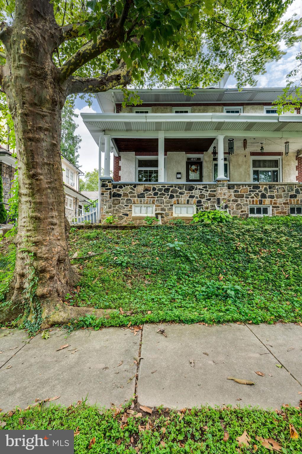 Welcome to this spacious 2.5 story home with a finished basement & two full bathrooms! Check out the natural beauty of the mature landscaping, complemented by an inviting covered front porch. Natural light imbues the semi-open concept layout with a cheerful charm, accented by lead-glass transom windows & hardwood floors. This layout flows from the living room into the dining room, then into a kitchen equipped with plenty of cabinet storage & counter space. Each bedroom is endowed with a generous scale & large windows. Head downstairs to the finished basement to discover the second full bathroom. The top floor is great for a quiet bedroom but can also be a perfect hobby space, office or playroom. Out back is private parking for two cars, plus a covered patio. So much space & potential awaits in this delightful home that blends historic elegance with everyday practicality! Schedule your showing today!
