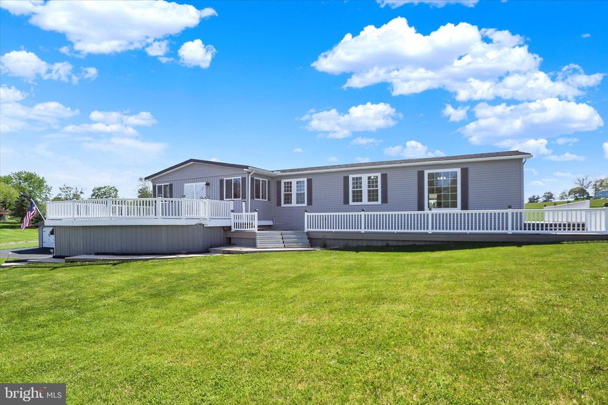 Discover a charming double-wide home that perfectly blends comfort and functionality. Built in 2001, this raised ranch-style residence boasts an impressive 3,436 sq. ft. of finished living space, featuring four spacious bedrooms and three and a half bathrooms. The heart of the home is complemented by a fully finished basement with a walkout entrance, providing additional space for relaxation, entertainment, in-law quarters or a variety of other possiblitlies. Step outside to enjoy extensive hardscaping, perfect for outdoor gatherings, along with a wrap-around porch where you can enjoy your morning coffee and unwind in the evenings. The property includes secure storage and an outbuilding, ideal for hobbies or extra storage needs. With both an attached garage and a detached garage offering ample parking for up to seven vehicles along with driveway parking, convenience is at your fingertips. Nestled in a welcoming community, this home is surrounded by well-maintained parks and recreational areas, perfect for outdoor enthusiasts. Local schools are known for their commitment to education, making this neighborhood a great place to thrive. Enjoy easy access to public services and amenities that enhance daily living. This property is not just a house; it's a place to create lasting memories. Embrace the warmth of this inviting home and the vibrant community that surrounds it. Your new chapter awaits!