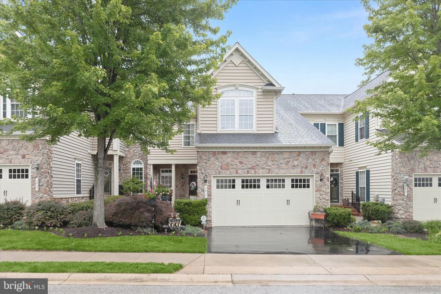 Welcome to 2605 Glencoe Circle, a storybook residence in the coveted 55+ Courtyards at Waverly Woods community, where refined living meets comfort and convenience. This Howard County treasure blends timeless elegance with effortless ease, beginning with a welcoming courtyard that welcomes you to the inviting front door and into soaring ceilings, gleaming hardwood floors, custom molding, and light-filled interiors that feel both grand and inviting. The chef’s kitchen is beautifully embellished with granite countertops, stainless steel appliances, a center island, decorative backsplash, breakfast bar, display cabinetry, and a pantry, every detail thoughtfully curated for both everyday living and entertaining. The open-concept family and dining rooms, anchored by a dramatic vaulted ceiling, flow seamlessly into the office/sunroom, which features cathedral ceilings and direct access to the deck. The main-level primary suite serves as a private retreat, complete with tray ceilings, custom box wainscoting, an expansive walk-in closet, and a spa-inspired full bath. A welcoming living room, powder room, and laundry room complete the main level. Upstairs, a versatile loft overlooking the main living area, two spacious bedrooms, a full bath, and abundant storage extend the home’s comfort and flexibility. The finished lower level offers exceptional additional living space featuring a sizable recreation room, bar area, potential fourth bedroom, bonus room with French doors, full bath, and additional storage. Life here offers more than just a beautiful home; it’s a lifestyle. Residents enjoy exceptional amenities including a clubhouse, fitness center, pool, pickleball and tennis courts, bocce courts, walking trails, gazebos, and EV charging stations. Ideally located near shopping, dining, and major commuter routes, this extraordinary residence combines luxury, low-maintenance living, and an unbeatable location. Recent updates include roof and gutters (May 2026), water heater (2018), dishwasher (2024), microwave (2018), garbage disposal (2017), and main and lower-level HVAC (2021).