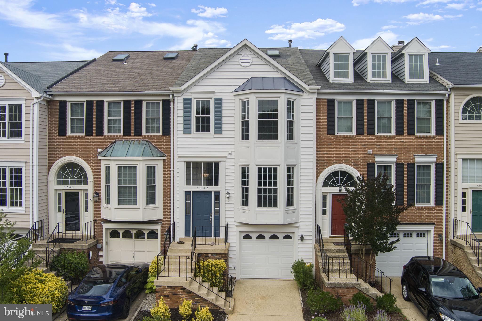 Welcome to 7005 Bentley Mill Place – a beautifully updated 3-bedroom, 2 full/2 half bath townhome in the heart of Kingstowne! This home provides cathedral ceilings, bright light, open living space with hardwood floors, renovated kitchen with quartz countertops, and a spacious rear deck perfect for entertaining with privacy. The luxurious primary suite features vaulted ceilings and a spa-like bath, while the finished walkout basement includes a cozy fireplace and flexible living space. Recent updates include: entire home painted (2025), refinished wood floors (2025), kitchen counters and floors updated (2025), deck repaired and painted (2025), entrance rail repaired and painted (2025), new windows (2019), exterior completely redone in PVC (2019), new roof (2019), new garage door with operating system (2019), new front door (2019), renovated bathroom on 3rd floor (2019), and split level HVAC system for efficient cooling. This home combines comfort, style, and convenience. Enjoy access to top-notch community amenities including multiple Kingstowne's pools, fitness center, tennis courts, lake, tot lots, and a variety of shopping and dining. Located near Metro, shops, dining, and major commuter routes. Don’t miss the opportunity to buy a home in a prime location. Home comes with 12 -month pre-paid home warranty to allow peace of mind.