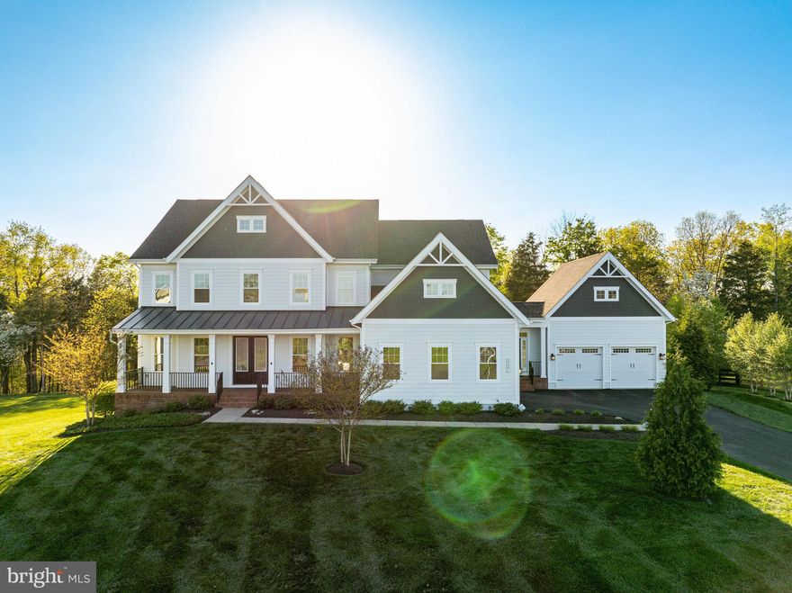 Welcome to the stunning EAST-facing luxury estate in Greens South-Willowsford, a magnificent residence nestled on one of Willowsford's largest homesites. Boasting over 6,800  finished square feet on three levels with high ceilings throughout, this home sits gracefully on a sprawling 1-acre premium cul-de-sac lot that backs to serene woods. As you enter, a touch of elegance welcomes you, with high ceilings leading into an open floor plan. The formal living and dining rooms seamlessly transition to a main-level office adorned with built-in shelves, versatile enough to serve as a main-level bedroom. The 2-story family room, featuring coffered ceilings and a stone fireplace, provides an ideal space for relaxation after a long day. Overlooking the family room, the kitchen is a chef's delight, equipped with double large quartz countertops, stainless steel appliances, 2 dishwasher's, soft-close cabinets, and a butler's pantry. An expanded mudroom with an informal front entrance and garage access adds convenience. Ascending to the upper level, discover the expansive owner's suite with a tray ceiling, a separate sitting area leading to a private balcony, and a designer master bath with dual vanities, a soaking tub, a dual-headed shower with jets, and a water closet. The suite also offers a light-filled walk-in closet organized by California Closets. Three generously sized bedrooms, each with its own full bath, complete the upper level. The lower level is an entertainer's haven, with high ceilings it features a large rec room, a separate media room, and a tastefully upgraded wet bar with wood paneling for added elegance. A full bedroom and bath provide additional accommodation options, which can also be used as an exercise or a second office space. Step outside to your personal oasis, where a large deck facing the woods and a stone patio with privacy walls offer breathtaking views of the mountains. The expansive lot extends beyond the fenced backyard, . Noteworthy features include a 4-car garage and a top-of-the-line security system. Embrace the Willowsford lifestyle with two elaborate clubhouses, resort-style pools, gyms, a 7-acre lake with a boathouse, dog parks, campgrounds, and more. Join community events, cooking demonstrations, volleyball games, and amphitheater concerts. Willowsford, a 4,000-acre farm-to-table community, with its 300-acre farm, garden, market, conservation areas, and miles of walking trails, is conveniently located less than 15 miles from Dulles International Airport and 35 miles from Washington DC. Being minutes from top rated schools, shopping, grocery and dining. If you seek privacy and elegance, your search ends here!
** Accepting Back up Offers**