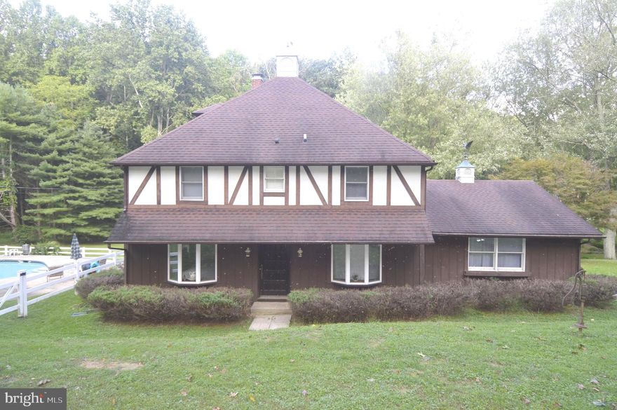 Beautiful tudor home on 8.5 Acres. This 4 bedroom 2 full bath offers very spacious and open rooms. Bedrooms are all great sizes.Upstairs bathroom has a jet tub and separate glass shower.Spacious kitchen w/propane cook top. Large windows can be found in almost every room allowing lots of natural light and views of the wildlife. The property boasts beautiful gated off in ground pool( 3.5 ft to 9 ft deep), a gorgeous stream running through entire property with a bridge to the other side,with plenty of great views from 2 decks. Roof age 20 Years w/ 50 year shingles. Anderson windows done in 1982. Oil furnace age 10. A/C age 10.Water heater age  7. A lot of big ticket items already done! 2 sheds. Two Parcels sold together. Entertainers dream property!