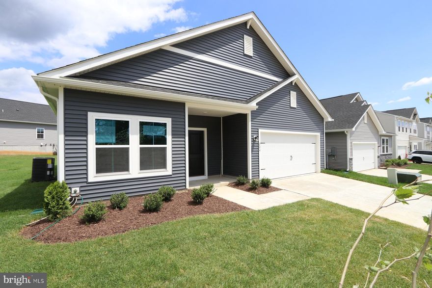 Memorial Day Special! Price just reduced PLUS $15,000 incentive—and this beautiful home will be Move-In Ready by June 2025! Welcome to the Daffodil, a stylish ranch-style home featuring an open-concept layout, 9’ ceilings, and luxury plank laminate flooring throughout (except in the bathrooms and laundry). The modern kitchen shines with stainless steel appliances, upgraded white cabinetry, a large quartz island, quartz countertops, subway tile backsplash, and a pantry—all designed to impress.
Relax in the lavish primary suite, complete with a huge walk-in closet, double vanities, and a frameless walk-in shower. Secondary bedrooms are thoughtfully located off the foyer near a full hall bath.
This home includes a GE washer/dryer package, utility sink, Wi-Fi-enabled 2-car garage door opener, and a Home Tech Package with CAT 6 wiring in all rooms, Wi-Fi keyless entry, WAP extender, and Ring doorbell.
Located in Liberty Run, right on the Jefferson County line in Berkeley County—a commuter’s dream with easy access to NOVA and DC. Basement options available on select lots.
Schedule your tour today to see our decorated model and learn about these amazing incentives!
Photos shown are of a similar Daffodil model. Taxes are estimated.