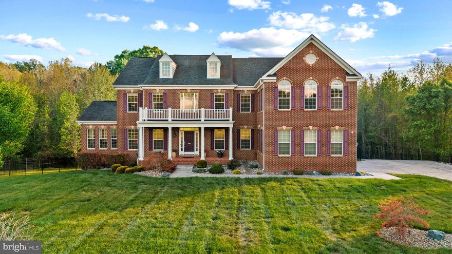 Welcome to your private estate retreat in the prestigious Windsong community, perfectly situated on nearly 9 acres of wooded grounds, offering a rare sense of seclusion and tranquility at the end of a quiet, no-outlet street.

This 4-bedroom, 5-bath Caruso Kingsport model offers over 7,300 square feet of finished living space, enhanced by a full rear bump-out across all levels, creating a more open and elevated layout.  
A grand two-story foyer makes an immediate impression with marble flooring, shadow box detailing, crown molding, and a dramatic dual staircase with an upper-level catwalk, setting the tone for the refined architectural design throughout. 

The main level serves as the heart of the home, featuring a two-story great room with ceramic tile flooring, coffered ceilings, a marble and glass tile gas fireplace, refined shadow box detailing, and floor -to-ceiling Palladian-style windows that fill the home with natural light.

The open-concept design flows seamlessly into the chef's kitchen, showcasing an oversized island, top-of-the-line appliances, a sunroom, a butler’s pantry, and more.  Additional main-level features include a formal dining room, living room, full bathroom, private office (or optional 5th bedroom), and a conservatory living area offering both comfort and versatility.

The upper-level private owner’s suite provides a true retreat, featuring a striking three-sided fireplace, spacious sitting areas, dual walk-in closets, and a spa-inspired bathroom. 3-generous-sized secondary bedrooms included well-appointed baths, with one offering a Jack-and-Jill layout. A full laundry room with cabinetry, adding everyday convenience, completes the 2nd level.

The fully finished walkout basement extends the home's living space, offering a wet bar, fitness room, full bath, and additional unfinished spaces, ideal for a home theater, wine cellar,   in-law suite, guest suite, or other extended living options.  

Outdoor living is equally impressive, with the sunroom leading to the main deck with stairs to the backyard and patios – ideal for gatherings.  On the opposite side of home, the conservatory opens to a more private deck with a hot tub, a mounted TV, and a retractable awning – perfect for quiet relaxation overlooking the peaceful wooded surroundings.  

This premium lot is further enhanced by a 3-car garage, whole house generator, aluminum fencing, an irrigation system, a shed, gas hookup for outdoor cooking, and numerous thoughtful upgrades throughout.