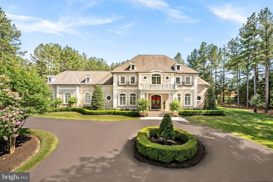 Welcome to a timeless masterpiece at 22608 Creighton Farms Drive—an exquisite French Manor estate, crafted with precision by Apex Custom Homes. This distinguished residence, nestled on a corner lot spanning over 3 acres, presents an opulent lifestyle with almost 10,000 square feet of luxurious living space.

As you arrive, a circular driveway flanked by monuments and large coach lights welcomes you. The grand entrance is adorned with front iron gate doors, leading to a two-story foyer with 25-foot ceilings and a floating solid wood staircase with iron spindles. The interior showcases chiseled travertine edge flooring, 8-inch reclaimed hardwoods, and detailed moldings throughout.

This estate features five bedrooms, each with en-suite marble or travertine bathrooms, and a primary suite on the main level boasting 16 foot ceilings,  dual chandeliers, and floor-to-ceiling marble surround fireplace with a 7-foot mantle.  The opulent primary bathroom features Calcutta marble floors, two water closets, a double sink vanity with a separate make-up area, soaking air jet bubble tub, spacious dual seamless glass walk-in shower, and a stunning John Richards chandelier.

The gourmet kitchen is a chef's dream, equipped with Wolf and Sub-Zero appliances, a 9.5-foot island with new quartz countertops/backsplash, and reverse osmosis water system.  

Indulge in leisure with a private home theater, wine cellar, and recreation room. The outdoor oasis includes an Pristine Acres heated, saltwater pool with spa, fire bowls, and an outdoor kitchen under a custom pavilion.   The newly added outdoor bathroom/pool changing house is a designers dream.  9 foot resort style fire table as well as a separate stand alone fireplace offer everything any entertainer would want in their backyard.  Security and convenience are ensured with a whole-house generator, alarm system, and gated community.   This estate is a sanctuary of elegance and comfort, awaiting its next discerning owner.