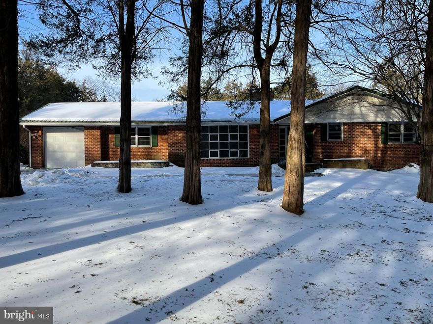 Is history part of your passion?  This wonderful property located within battlefield historic district boundary has so much to offer!  The brick ranch sits on 4.35 acres...partly wooded, and very private. The long driveway winds you in past a pond on your right, to a huge parking area and the home's entrance. The home boasts a double fireplace.... in the formal living room and eat-in kitchen area. Family room exits to the pool area and secluded backyard.  Bring your creative ideas and updates to make this home your own. It truly is worth a look. One-of-a kind setting!!!