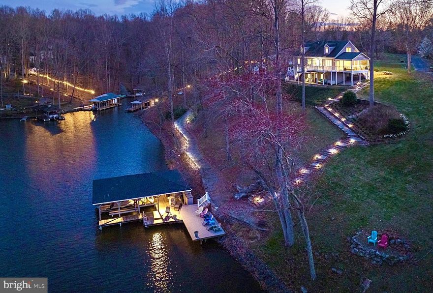 Nestled along the serene shores of Lake Anna in Mineral, Virginia, 6217 Connie Lane stands as a quintessential waterfront retreat on the public side of the lake, offering unparalleled tranquility and comfort amidst nature's splendor. This exquisite property epitomizes lakeside living at its finest with captivating water views, deep water (14-16 feet deep) at the end of boathouse, and extensive hardscaping that seamlessly blends with the natural landscape. Situated on a prime waterfront lot with 375 feet of shoreline in a no wake zone, this home offers breathtaking vistas of Lake Anna from every angle, inviting you to unwind and immerse yourself in the beauty of your surroundings. Cul-de-sac location and sitting perfectly on a 1 acre lot with high speed Xfinity Comcast internet! Step inside, to this 3 bedroom, 3.5 bath retreat that offers over 3,000 square feet and a finished walkout basement that has a Murphy bed and custom barn doors. The main living area features expansive windows that frame panoramic views of the lake, allowing natural light to flood the space and create a warm and inviting ambiance. Whether you're preparing a casual meal for family or hosting guests, the kitchen is a chef's delight, equipped with stainless appliances, granite countertops and a breakfast bar, providing the perfect setting to indulge your culinary passions while enjoying sweeping water views. The home's layout is designed for seamless indoor-outdoor living, featuring a screened porch creating the perfect spot to savor your morning coffee, expansive back deck for grilling and dining or relax and take in the views from the covered waterproof patio. Here, you'll find the true heart of the home—a sprawling outdoor oasis that serves as an idyllic setting for al fresco dining, entertaining guests, or simply relaxing in the sun as you listen to the gentle lapping of the waves against the shoreline. The centerpiece of the outdoor space is undoubtedly the large boathouse, offering two slips with electric lifts for your watercraft's (one lift for your boat and one has two lifts for your jet skis), partially covered sun deck, storage room and deep water. There is also a golf cart path direct from the house to the boathouse. Whether you're a boating enthusiast eager to explore the vast expanse of Lake Anna or simply seeking a tranquil spot to fish or swim, the boathouse provides endless opportunities for aquatic adventures right in your back yard. The beauty extends beyond its stunning waterfront location. The property features extensive hardscaping, including a meticulously landscaped yard, stone pathways and a paved driveway. Wifi enabled lake fed irrigation. For those who crave adventure, Lake Anna offers a wealth of recreational opportunities just steps from your door. Spend your days boating, waterskiing, or paddle boarding on the water, or relax and entertain on the boathouse. When it's time to unwind, retreat to the comfort of your main level primary suite that features a double vanity, soaking tub, separate shower and a walk-in closet. Additional bedrooms and bathrooms provide ample space for family and guests, ensuring everyone feels right at home in this lakeside paradise. Two car finished garage and the shed conveys. Beyond its natural beauty and recreational opportunities, Lake Anna boasts a vibrant community and a host of amenities for you to enjoy. From charming local shops, restaurants, and several breweries and wineries, the area offers something for everyone, making it the perfect place to call home. This retreat is the epitome of waterfront living and offers the perfect blend of lakeside living, comfort, and natural beauty. Don't miss your chance to experience the ultimate lakeside lifestyle—schedule your private showing today!