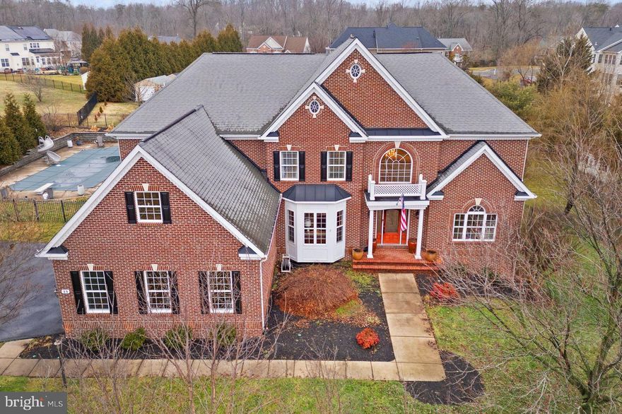 Make a splash in this luxury and upscale Deacon Hill Estates pool home, offered below appraised value with a rare low-interest VA assumable loan.

Built by Caruso Homes (Monticello model) and offering approximately 8,000 square feet on 1 acre, this 5-bedroom, 4 full and 2 half-bath Colonial stands among the largest floorplans in Deacon Hill Estates. A March 2026 appraisal reflects a value higher than the current list price, presenting an exceptional opportunity for built in equity.

Located on a quiet street with sidewalks and mature landscaping, the home is just minutes to Historic Downtown Fredericksburg, shopping and dining, commuter routes, and Stafford County schools including Grafton Village Elementary.

The fully fenced backyard is designed for entertaining and everyday enjoyment. The L-shaped in-ground pool (3–9.5 ft depth) with diving board and buddy seat anchors the space, complemented by a 1,200 sq ft Trex deck, stamped concrete patio, gazebo, irrigation system (7 zones), outdoor lighting, storage shed, and aluminum fencing with dual gates. A built-in Paradise Grills outdoor kitchen features a gas grill with rotisserie, stainless refrigerator, bar seating, and wiring for an outdoor TV creating a true resort-style setting.

Inside, Brazilian cherry hardwood flooring spans the main level, enhanced by recessed lighting and fresh interior paint (2022). Architectural details include tray and vaulted ceilings, along with gas fireplaces in both the living room and primary suite.

The 2022-updated kitchen showcases Matarazzo quartzite countertops, travertine tile flooring, upgraded cabinetry with under-cabinet lighting, Monogram induction cooktop (2022), KitchenAid twin 30” convection ovens (2022), GE Profile refrigerator (2022), and KitchenAid dishwasher (2021). The eat-in layout opens seamlessly to the main living area, ideal for entertaining.

Upstairs, the spacious primary suite includes a sitting area, large walk-in closet, gas fireplace, and private ensuite bath. A dedicated upper-level fitness room features reinforced flooring supported by steel joists. Additional bedrooms are generously sized with well-appointed ensuite baths.

The walkout basement offers a wet bar with granite countertops, cherry cabinetry, double sink, and mini refrigerator, along with a media room, full bath with double vanity, flexible guest bedroom, and approximately 1,000 square feet of unfinished storage.

Major system updates provide peach of mind, including a high-efficiency Carrier 26 SEER HVAC system installed in 2022 with 8-zone climate control, a secondary Goodman 2-zone HVAC system and a 75-gallon water heater approximately 4 years old. Additional improvements include upgraded mudroom with cubbies and most toilets replaced in 2022, reflecting continued care and thoughtful maintenance throughout the home. 

For qualified buyers, the existing low-interest VA loan may be assumable offering a rare financing opportunity in today’s market.

This home combines scale, thoughtful updates, outdoor living, and value all in a prime Stafford County location.