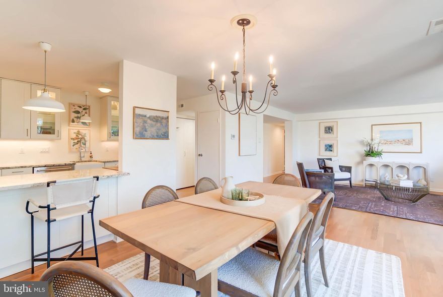 Welcome to the ultimate in CONVENIENCE, LIVABILITY and ACCESSIBILITY- with NO STAIRS into the building (only 4 of 16 buildings in the development can say the same) or in the unit itself, an ASSIGNED PARKING SPACE and an EXTRA LARGE STORAGE UNIT- in the highly sought after Sumner Village Community. At 1410 square feet with an open concept living, dining and kitchen area as well as an EXPANSIVE PRIVATE BALCONY with treetop views, Unit 302 (conveniently located directly across from the elevator) boasts one of the most desirable two bedroom, two bathroom floorplans within the complex. It also features a gorgeously RENOVATED KITCHEN with KitchenAid stainless steel appliances, ample cabinetry, a farmhouse sink and beautiful granite wraparound counters. An open breakfast bar fills the kitchen with natural light from the wall of windows in the dining area and supplements the warm pendant and under cabinet lighting creating a bright, beautiful space to cook and entertain. Additional standout features of this residence include two generously sized bedrooms, including a phenomenal primary suite with a walk-in closet and updated bath, UNBELIEVABLE CLOSET SPACE (6 totals closets, including two walk-in closets -one of which is 14' long!), AUTOMATED SUN SHADES THROUGHOUT, side by side washer/dryer in-unit, and modern, low maintenance flooring.

Sumner Village is an amenity-rich, gated community set on 27 acres of beautifully landscaped grounds bordering parkland and the Capital Crescent Trail. Residents enjoy a 24-hour staffed entrance, outdoor pool, tennis and pickleball courts, fitness and clubhouse facilities, sauna, library, and scenic walking and biking paths. Just moments from Safeway, Starbucks, local dining, Glen Echo Park, and downtown Bethesda, the community offers a rare blend of natural tranquility and everyday convenience—along with a lively calendar of neighborhood events.