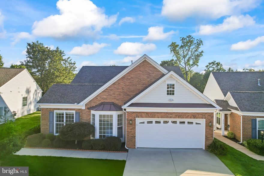 Welcome to 2013 Cheltenham Court, a beautiful 2,198 sq ft, 2-bedroom, 2-bathroom home nestled in the highly desirable River Ridge 55+ active adult community in Lake Ridge, VA. This spacious one-level home features an open-concept design with a bright and inviting living area that flows seamlessly into the dining and kitchen spaces, creating a perfect setting for everyday living and entertaining. Step outside onto the large deck, complete with an automated retractable awning, where you can enjoy peaceful outdoor living with views of the landscaped backyard.

The home also includes a versatile office/den, ideal for a home office or hobby space. The well-appointed kitchen offers abundant cabinetry, ample counter space, and a cozy breakfast nook. The spacious primary suite features a large walk-in closet and an en-suite bath with a double vanity and walk-in shower, while the second bedroom is generously sized and conveniently located near the second full bath.

An extended sunroom bump-out adds even more living space and natural light, providing a comfortable retreat year-round. Additional highlights of the home include an oversized 2-car garage, a laundry room with full-size washer and dryer, and easy-care flooring throughout the main living areas.

River Ridge offers a wealth of amenities including a clubhouse, fitness center, outdoor pool, tennis courts, and walking trails, along with a variety of social events to keep residents active and engaged. Ideally located near shopping, dining, historic Occoquan, and outdoor recreation, this home also offers convenient access to I-95, VRE, and Washington, DC.