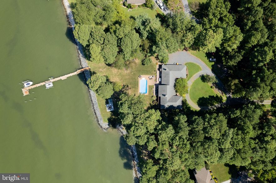 A dramatic contemporary sited on 9.30+/- acres along the shores of Eastern Bay, and only minutes from Historic St. Michaels and Tilghman Island.  The approach to this home is a serpentine driveway through natural woodlands.  As you enter the foyer you are immediately  greeted with stunning views of Eastern Bay, and from most rooms throughout the house.  The property has had many upgrades since 2008 including the kitchen and baths.  There are several levels creating a myriad of possiblities.  The great room with cathedral ceilings and wood burning fireplace are just off the kitchen with island, bar seating and formal dining room.  The upper level has the owner's suite with balcony to enjoy the views and breezes.  Two additional bedrooms and a full bath complete the second floor.  The lower level has two bedrooms, a full bath and den with brick hearth fireplace.  There is a separate entrance making it perfect for family, friends or a nanny.  There is an in-ground saltwater pool on the water side of the house, outdoor shower, rear deck and patio with firepit that offers the same great views.  A pier with approx. 3'+/- MLW, several boat lifts, and from this location you can jet ski to Lowe's Wharf, Tilghman Island or St. Michaels.  An attached 3-car garage and many other amenties round out this beautiful home.  The woodlands house an abunadance of wildlife and the eagles are Free!  *Water depth to be verified by buyer. *Septic is approved for 4 bedrooms.   Buyer was unable to obtain financing. All inspections were completed, and Sage Title Group in Bethesda, MD were prepared for settlement. Call with questions.