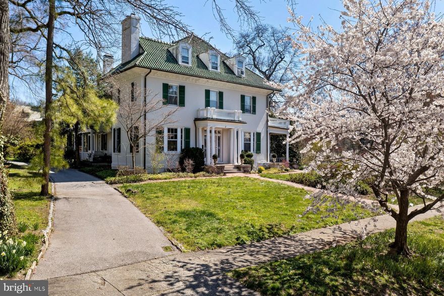 This grand Colonial Revival home is sited directly across from William Law Olmsted's beloved Sherwood Gardens.  With deep mahogany wood, solid panel doors and diffused light glowing from period chandeliers and sconces, there is an ambiance and reminiscent feeling of a bygone era.  Imbued with rich and sumptuous architectural details, finishes and appointments throughout, this home delights at every turn.  The house was constructed with over 10,000 square feet of living space, offering ample room to create a personal sanctuary in which to live your very best life.  The first floor living room, parlor and various dining areas provide the perfect backdrop for entertaining and spending time with friends.  The second and third floors provide ten or more rooms for use as bedrooms or studies, or any other purpose you see fit.  Head to the lower level for movie night, a game of pool or a libation from the custom built-in bar.  The Carriage House located on the property has been reinvented as an additional living space, replete with a kitchen and dining area, a spacious living room and an upstairs bedroom with hallway bathroom.  Your guest, in-laws or au-pair will enjoy comfort and privacy just steps away from the main house.  The grounds and secluded pocket park behind the property are perfect for an evening stroll or ball toss, and the gracious columned side portico is the perfect spot for people-watching, relaxing, sharing secrets and dishing the latest gossip.  This residence has hosted decades of creativity, friendship and fine living.  It is standing by to witness the memories yet to be made - the new stories yet to be told.  See Virtual Tour for Interactive Floor Plan.