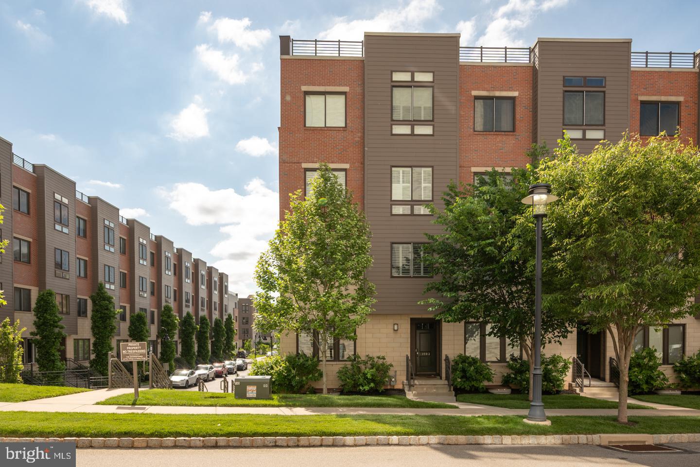 Welcome to this stunning 3-bedroom, 2.5-bath end-unit condo in the sought-after King of Prussia area, featuring a thoughtful floor plan, top-tier finishes, and abundant natural light throughout. Step into the open living level where hardwood floors flow seamlessly through the dining room, kitchen, and expansive great room. The upgraded kitchen boasts elegant pewter cabinetry, sleek white quartz countertops, and premium stainless steel appliances including a Bosch dishwasher, Samsung refrigerator, and Whirlpool microwave and oven. The space is perfect for both everyday living and entertaining, with access to one of two extended covered balconies that provide additional outdoor space and two large storage closets. Upstairs, you’ll find three spacious bedrooms, including a luxurious primary suite with tray ceilings, a walk-in closet, and a spa-like en-suite bath. The upper-level hallway and master bedroom feature hardwood flooring, while the two guest bedrooms have plush carpet for added comfort. A conveniently located laundry room and a full hall bath complete this level. The unfinished lower level includes rough-in plumbing, offering an easy path to adding a bathroom and customizing the space to your needs — ideal for a future home office, gym, or bonus living area. Additional features include a 1-car garage, keypad entry, and ample storage throughout. All windows are outfitted with modern 4.5-inch louvers, adding a clean, stylish finish while allowing for precise light control and privacy. As an end unit, this home enjoys tons of natural light from extra side windows — a rare and coveted feature in condo living. Just a short walk to the King of Prussia Town Center, shops, dining, and more!