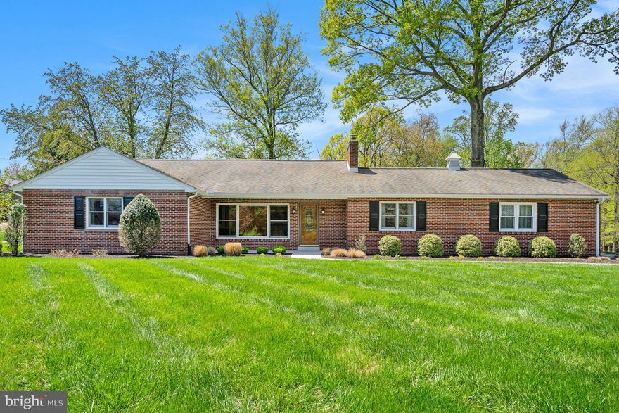 What a find in the Methacton School District.  This beautifully maintained and lovingly updated brick home has everything you are looking for.  Situated on a .64 ace lot the home is set back from the road to enjoy the lovely bucolic views.  Landscaping, a lovely lawn, new sidewalk and front porch welcome you to a gorgeous front door with leaded glass protected by a Pella storm door with removable screen.  You'll immediately notice the gleaming hardwood floors, fresh neutral paint and four panel solid core doors that extend throughout the entire home!  The living room is stunning with an expansive triple window offering panoramic views of the lush front lawn.  Notice the recessed lighting and beautiful painted stone accent wall surrounding the wood burning fireplace with raised hearth and mantle.  The owners are also including the Panasonic flat screen TV.  Continue into the formal dining room, with recessed lighting, a chandelier, double window overlooking the rear yard and a Pella door leading to a patio perfect for all your outdoor entertaining needs!  The kitchen is accessed through double doors and has been upgraded with 42" antique white recessed panel cabinetry with crown molding, under cabinet lighting, quartz counters, subway tile backsplash and under-mount stainless steel sink with Moen gooseneck oil rubbed bronze faucet situated under a double casement window.  There's plenty of room for a kitchen table to enjoy a casual meal or cup of coffee.  Other features include a composite tile floor, recessed lighting and a built-in pantry.  Appliances - Samsung stainless steel smooth surface electric convection range,  Bosch dishwasher,  Broan vented hood, and LG stainless steel French door refrigerator.  The adjacent utility room has a composite tile floor, a broom closet, double window, a door to the patio as well as garage access, a utility sink and the LG front loading washer and dryer (Thin Q) with a convenient phone app (2024) are included!  On the opposite end of the home you'll find 3 bedrooms and 2 full baths surrounding a hall with a double linen closet.  The primary suite is large and sunny with a double window, recessed lighting, TWO double closets and an ensuite full bath with linen closet, cast iron tub, pedestal sink, mirrored medicine cabinet, window with privacy glass and gorgeous retro blue tiled floor walls and tubs surround that is a MUST see to appreciate how well done it is!  Bedrooms 2 and 3 are both bright and sunny with large closets and share another full bath with linen closet, pedestal sink, mirrored medicine cabinet, window with privacy glass, cast iron tub and more striking retro tile in green!  The home has a full unfinished basement with Bilco doors, brand new steps to the exterior and a sump pump that would be perfect to add more living space as well as providing incredible storage.  Need more storage?  There's a full attic as well as a shed in the rear yard.  So much has been done to make this home ready for you - new gutters and siding (2024), newer Pella replacement windows, a Lennox A/C  and Honeywell programmable thermostat, water softener, new oil tank and Walton installed Ascent boiler (2022) (two zone heat), whole house insulation and even a One Year AHS Home Warranty.  Don't miss this wonderful opportunity!