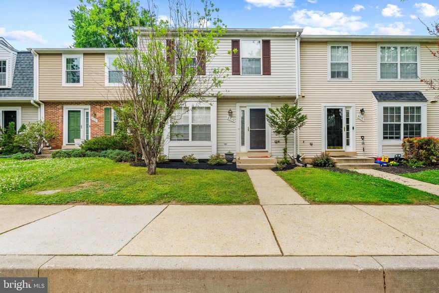 A beautifully maintained townhouse residence offering 3 bedrooms, 2.5 bathrooms, and 2,273 square feet in sought-after Dorsey Hall. // A welcoming foyer with updated vinyl flooring (2026) opens with a convenient powder room and immediate access to the eat-in kitchen, also featuring updated vinyl flooring (2026). Designed for both functionality and connection, the kitchen showcases white cabinetry, a center island with breakfast bar seating, a subway tile backsplash, select stainless steel appliances, including a dishwasher and microwave replaced in 2025, and a refrigerator updated in 2017, plus a pass-through window overlooking the main living area for a seamless flow. // The open-concept main level is designed for comfortable everyday living and effortless entertaining, featuring a dining area accented by a modern chandelier and a spacious living room with built-in shelving, a cozy fireplace, and access to the deck. Natural light pours into the space, while elegant chair rail molding adds a touch of character throughout. // Upstairs, the primary suite offers a relaxing retreat with chair rail molding detail, a ceiling fan, dual closets, and a private ensuite bath showcasing rustic Mediterranean-inspired tilework and a jetted bathtub. Two additional bedrooms and a full bathroom complete the upper level. // The lower level expands the living space with a recreation room featuring plush carpeting and recessed lighting, creating an ideal setting for lounging, movie nights, or casual entertaining, along with a utility/laundry room with a dryer replaced in 2021. // Outdoor living continues on the two-tiered deck, which steps down to an open green space for a peaceful outdoor backdrop. Additional updates include the water heater (2024) and roof (2017). Select photos are virtually staged.